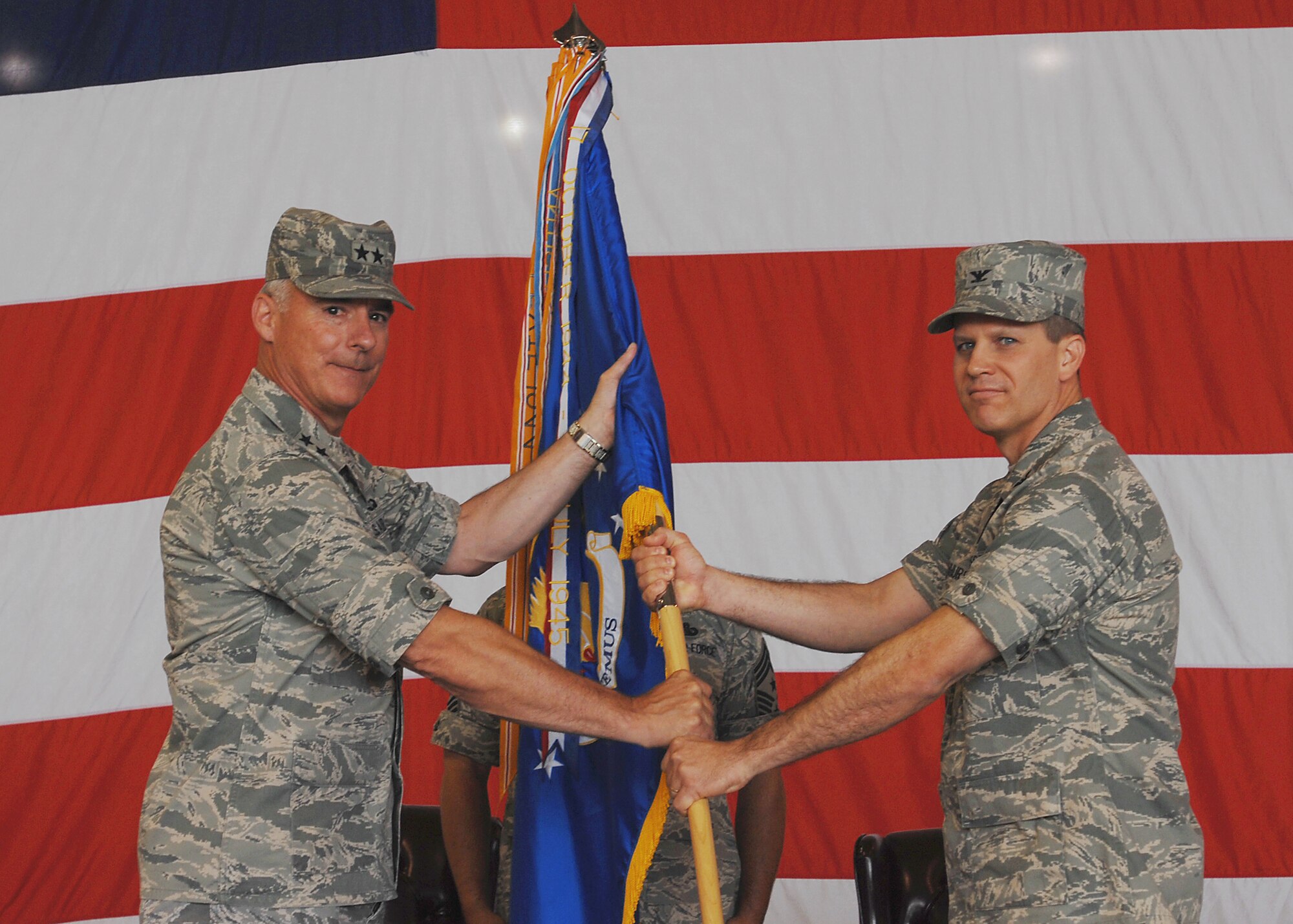 MCCONNELL AIR FORCE BASE, Kan. -- Maj. Gen. Winfield W. Scott III, 18th Air Force commander, Scott Air Force Base, Ill., passes the 22nd Air Refueling Wing guidon to Col. Jamie Crowhurst, giving him command of the wing during a change of command ceremony, July 2. Colonel Crowhurst succeeds Col. James C. Vechery who makes his transition to become the wing commander for Travis Air Force Base, Calif. (Photo by Staff Sgt. Jamie Train)