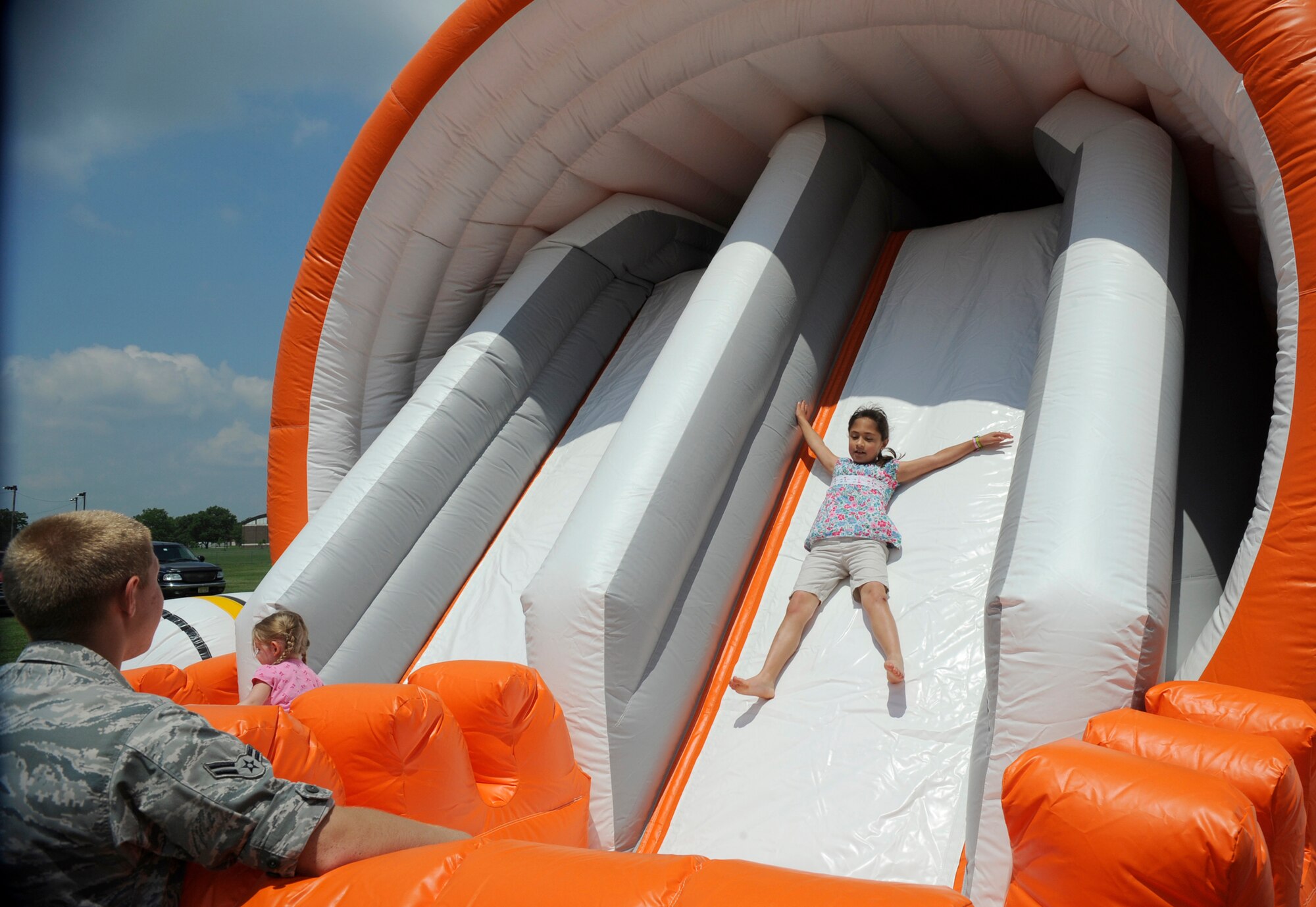 Children enjoyed playing on the giant inflatable slide during the MatchUp Picnic 2009 outside The Club July 2. More than 1500 Joint Base McGuire-Dix-Lakehurst members attended the free event, which was organized by the 87th Force Support Squadron’s marketing department. (U.S. Air Force photo/Carlos Cintron)