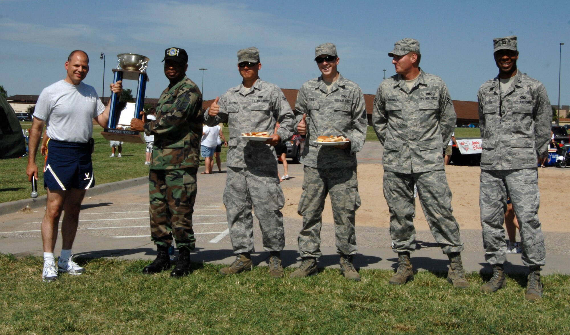 MCCONNELL AIR FORCE BASE, Kan. -- Col. James C. Vechery, former 22nd Air Refueling Wing commander, awards Senior Master Sgt. Phil Campbell, 22nd Aircraft Maintenance Squadron the Commander’s Trophy Cup for winning this year’s Wing Intramural Sports Program, July 1. Receiving the award alongside Sergeant Campbell was Airman Nathan Houzenga, Airmen 1st Class Cameron Forte, Clayton Thuernagle and Capt. James Hodges, 22nd Aircraft Maintenance Squadron. (Photo by Senior Airman Laura Suttles)