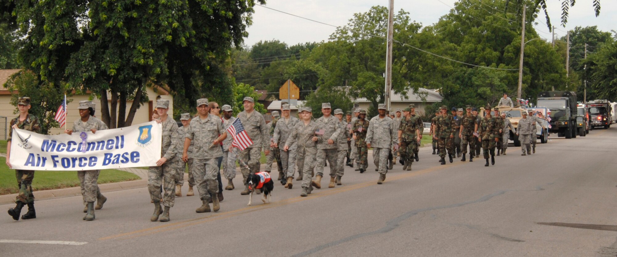 MCCONNELL AIR FORCE BASE, Kan. -- Team McConnell members participate in a Fourth of July parade in downtown Derby. The parade, an annual event for more than 45 years, recognized military members, past and present who fought for the freedom and the rights of the American people. (Photo by Senior Airman Laura Suttles)