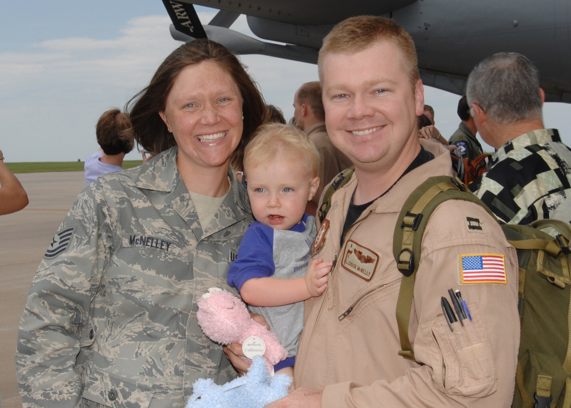 MCCONNELL AIR FORCE BASE, Kan. -- Capt. Charley McNelley is welcomed home by his wife Tech. Sgt Rebecca McNelley, 22nd Force Support Squadron, and their son Jacob, 2, after his deployment to Al Udeid Air Base, Qatar, July 2. (Photo by Staff Sgt. Jamie Train)