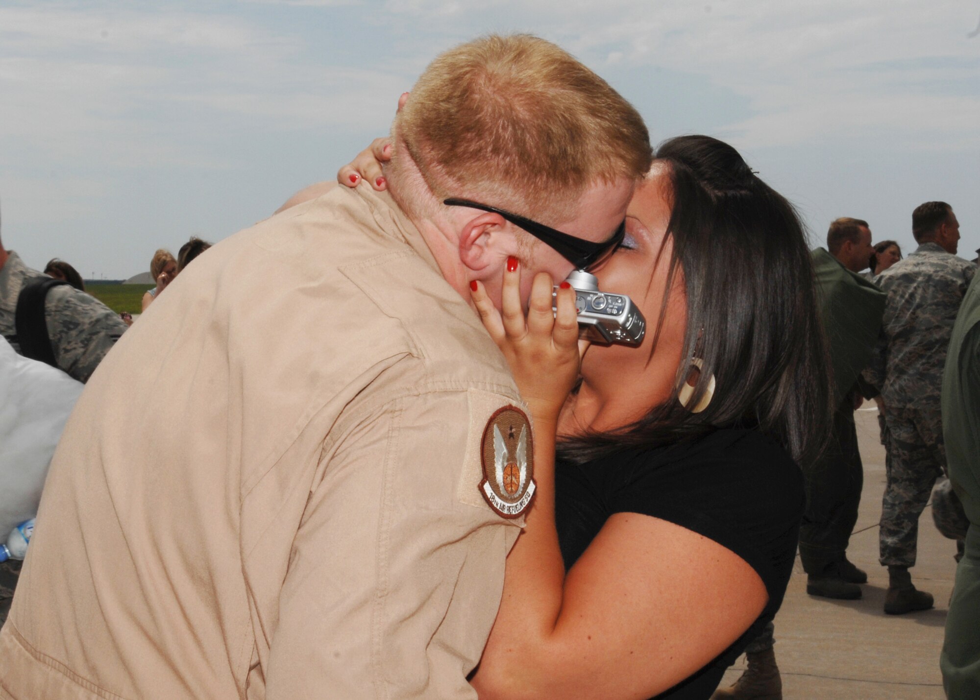 MCCONNELL AIR FORCE BASE, Kan. -- Tech. Sgt. Christopher Norris, 18th Air Refueling Squadron, receives a welcome home kiss after his return from Al Udeid Air Base, Qatar, July 2. (Photo by Staff Sgt. Jamie Train)