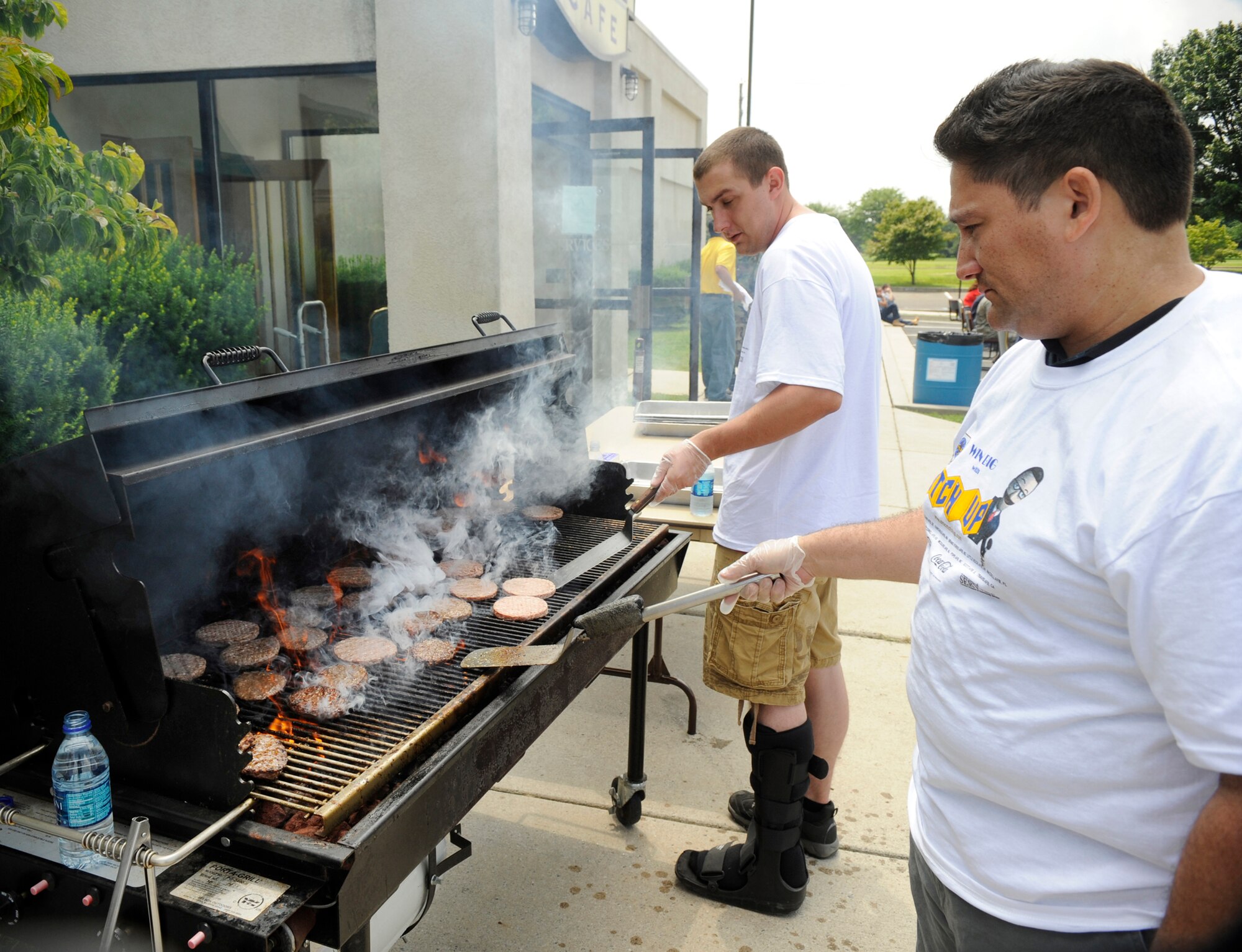 Volunteers grill burgers during the MatchUp Picnic 2009 at The Club July 2. More than 50 volunteers helped make the picnic possible for Joint Base McGuire-Dix-Lakehurst members. (U.S. Air Force photo/Carlos Cintron)