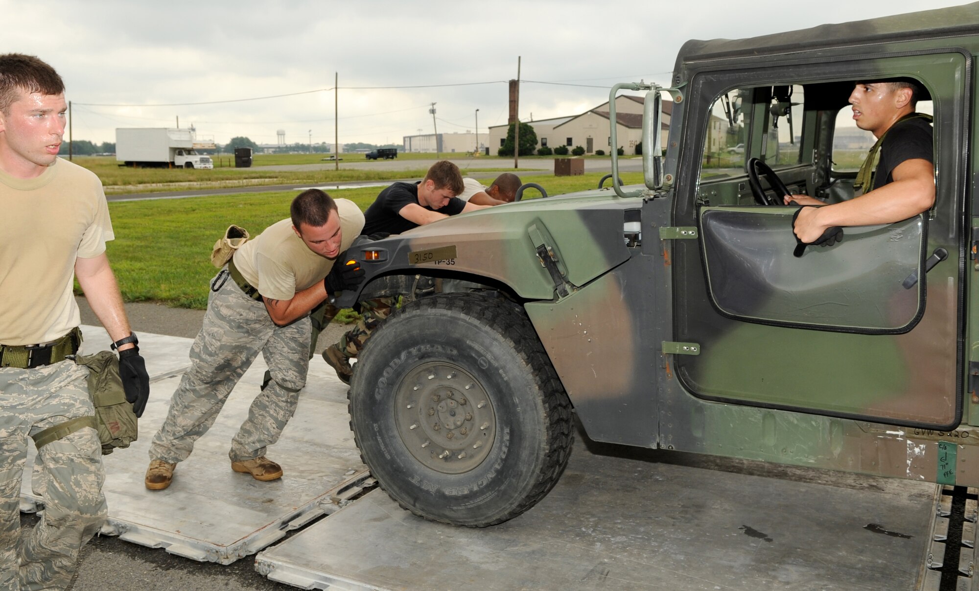 Known around the base as expert movers and cargo handlers, the 305th Aerial Port Squadron Rodeo team demonstrates its abilities by positioning and prepping a military humvee for air transportation during the obstacle course July 2. (U.S. Air Force photo/Wayne Russell)
