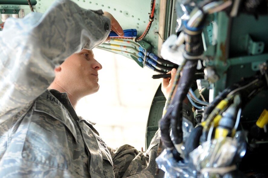 Technical Sgt. Ian Hallinan, 4th Equipment Maintenance Squadron, inspects an F-15E Strike Eagle wire routing in a hangar on Seymour Johnson Air Force Base N.C., June 30, 2009. As the 4th Fighter Wing avionics manager, Sergeant Hallinan is the liaison between aviation contractors such as Boeing and Lear Siegler Inc., and Air Force units at Seymour Johnson AFB, Wright-Patterson AFB, Ohio, and Robins AFB, Ga. (U.S. Air Force photo by Airman 1st Class Whitney S. Lambert) 