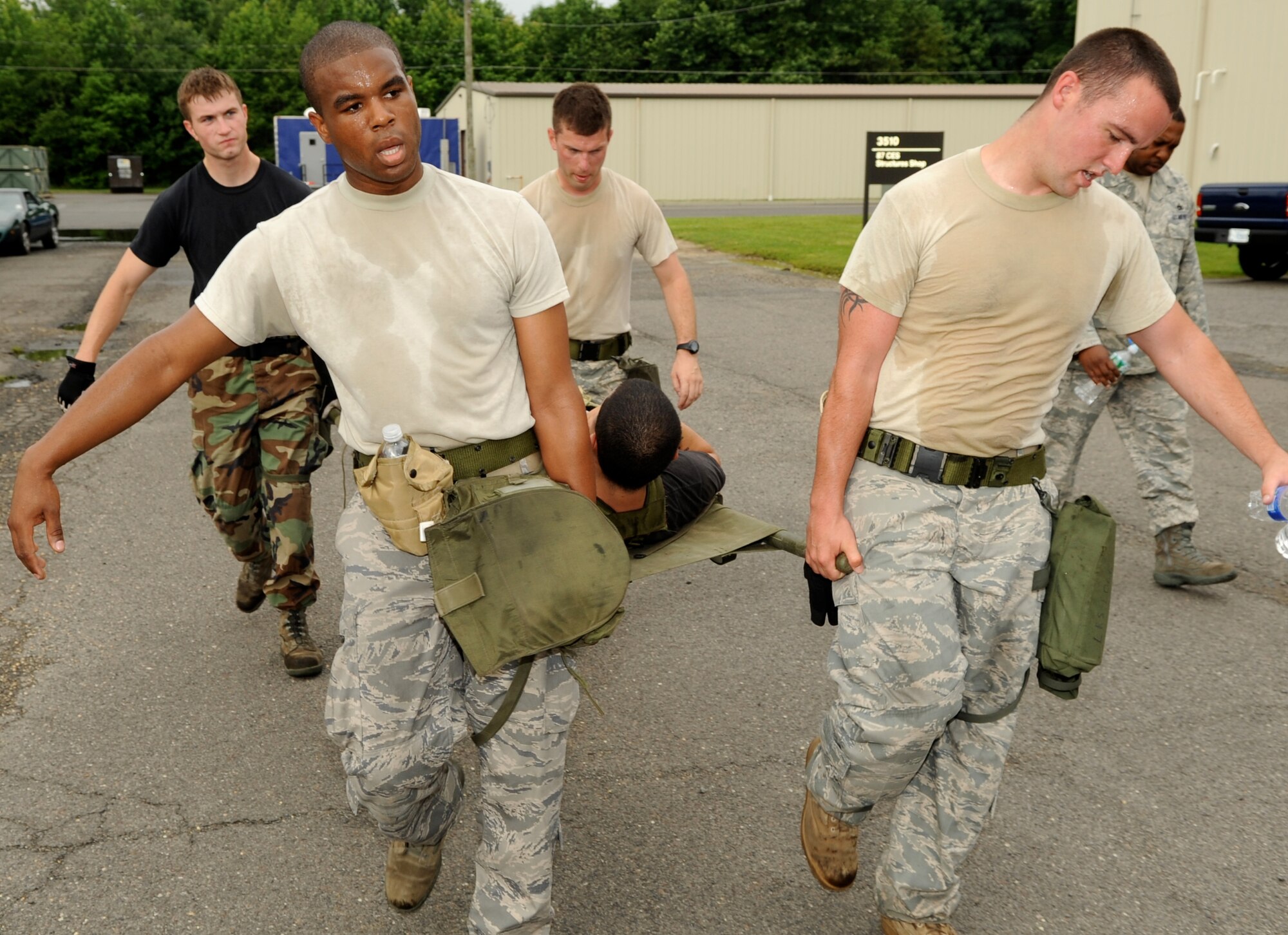 The 305th Aerial Port Squadron Rodeo Team triages and litter-carries an "injured" team member during one of the tasks of the obstacle course July 2 in preparation for the Rodeo 2009 competition. (U.S. Air Force photo/Wayne Russell)

