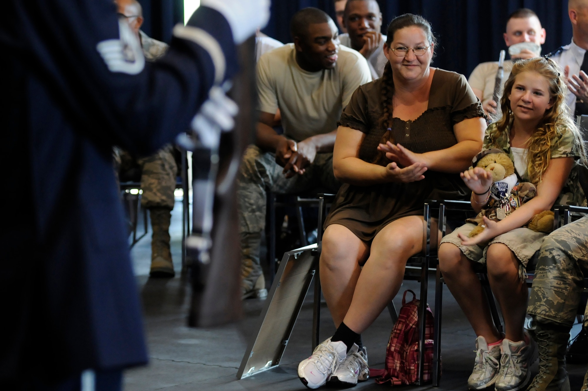 Bailey Reese, founder and president of the non-profit organization, Hero Hugs, and her mother, Diana, applaud during United States Air Force Honor Guard Drill Team’s evaluations July 7 on Bolling Air Force Base, D.C. Bailey is the youngest person to ever start a non-profit organization and has received numerous awards for her work to include being honored for her contribution to U.S. military morale by President George W. Bush. (U.S. Air Force photo by Staff Sgt. Dan DeCook)
