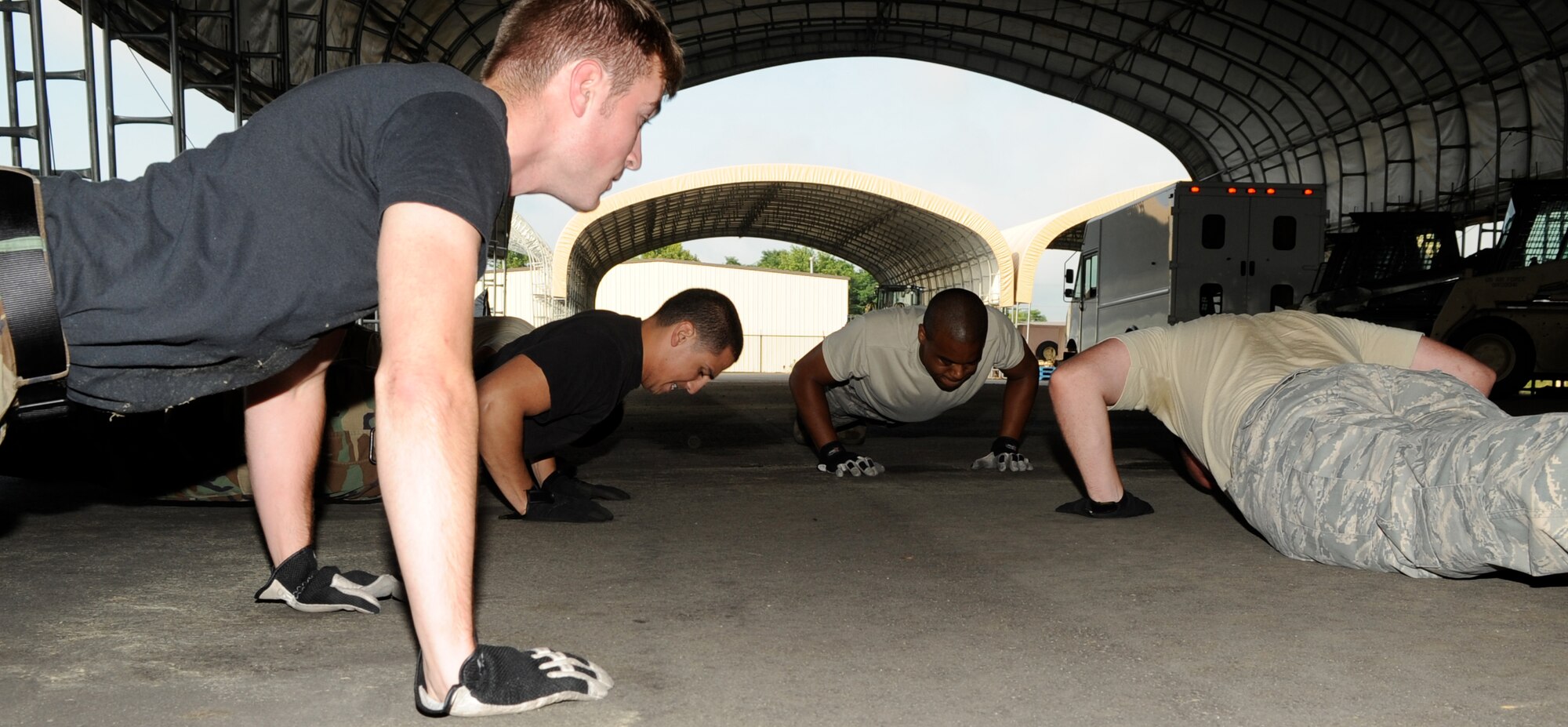 After the crunches, the 305th Aerial Port Squadron Rodeo Team pushes out two minutes of push-ups and then runs a 1/4-mile lap. Rodeo is an annual competition where units like the 305th APS send out their best representatives to be judged and compete against other units throughout the Air Force. They are usually judged on team cohesiveness, job skill and knowledge, attention to detail, safety and speed.  
(U.S. Air Force photo/Wayne Russell)
