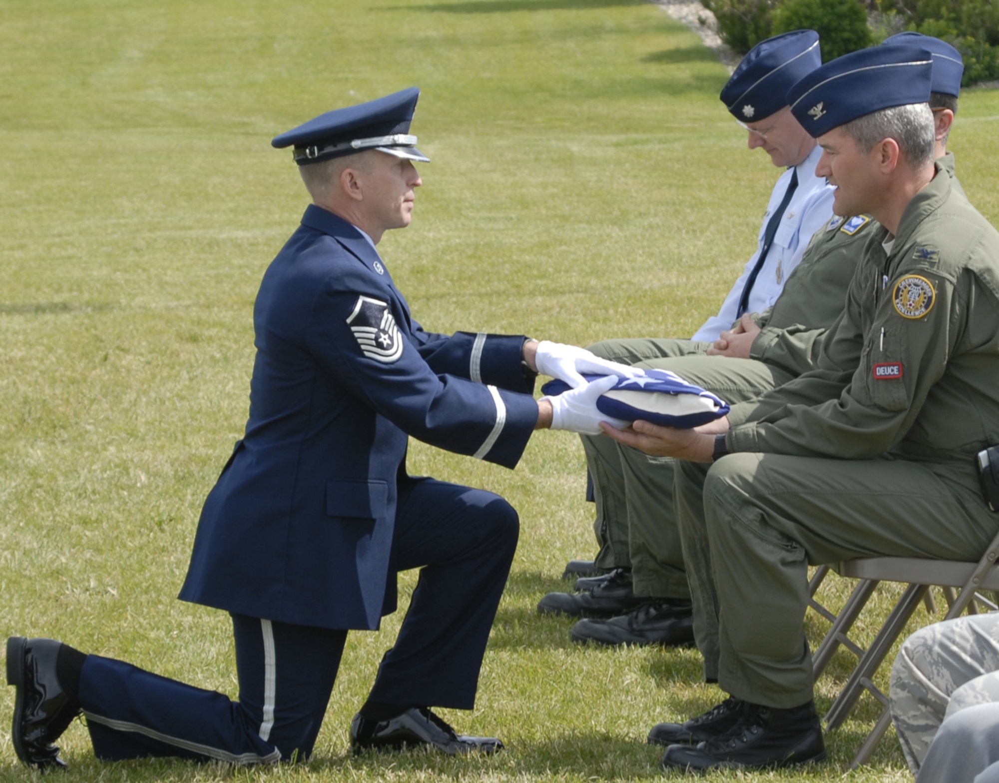 Master Sgt. Jeff Parker, NCO in charge of the Malmstrom Honor Guard, delivers the message of condolence to Col. Paul Gydesen, 341st Missile Wing vice commander June 24 at Medal of Honor Park. Full-honor funerals are performed for Airmen who are killed while serving on active duty. (U.S. Air Force photo/Beau Wade)