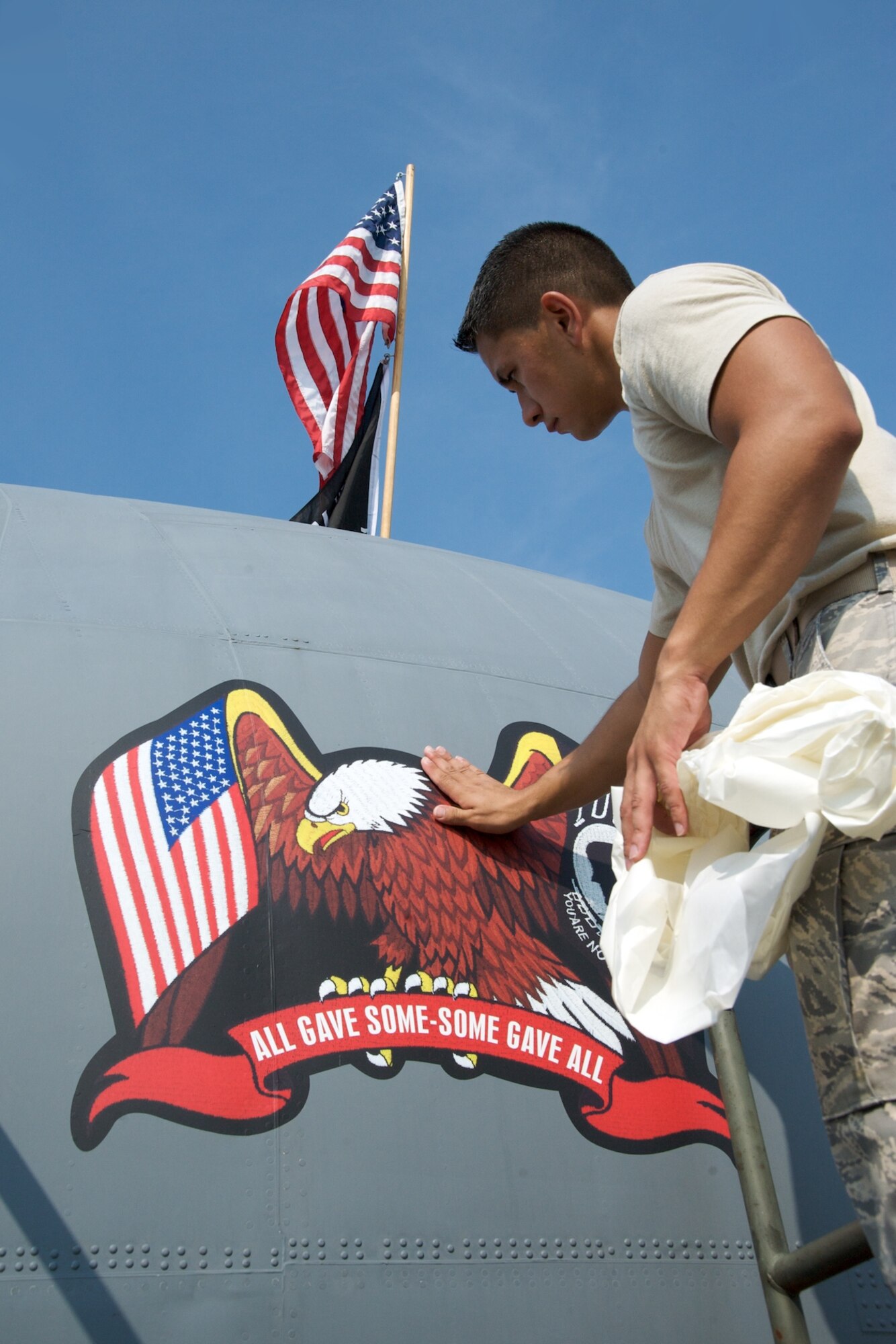 Senior Airman Mike Rutherford puts the final touches to the POW/MIA artwork on the 815th Airlift Squadron Flying Jenny aircraft 8156.

The Citizen Airmen of the 403rd Wing pay tribute to those who paid the ultimate sacrifice by placing the emblem on the nose of the aircraft.

Plans for a formal ceremony dedicating the aircraft to veterans are being formalized.

(U.S. AIr Force Photo by Maj. Chad E. Gibson)