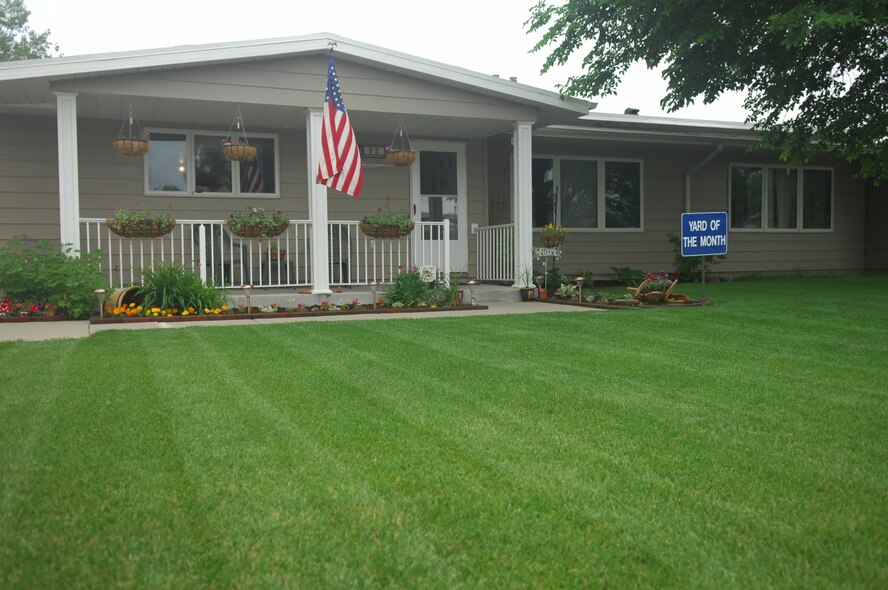 MINOT AIR FORCE BASE, N.D. -- The meticulously maintained Thompson residence here earned Staff Sgt. Vernon Thompson, 791st Missile Security Forces Squadron and his spouse Lindsay, yard of the month for June. The Thompsons received a $100.00 saving bond from the Minot Chapter of the Air Force Association, a $10.00 gift card from AAFES, and $15.00 in Darby Dollars to spend in 5th Force Support Squadron facilities. (U.S. Air Force photo by Senior Airman Wesley Wright)