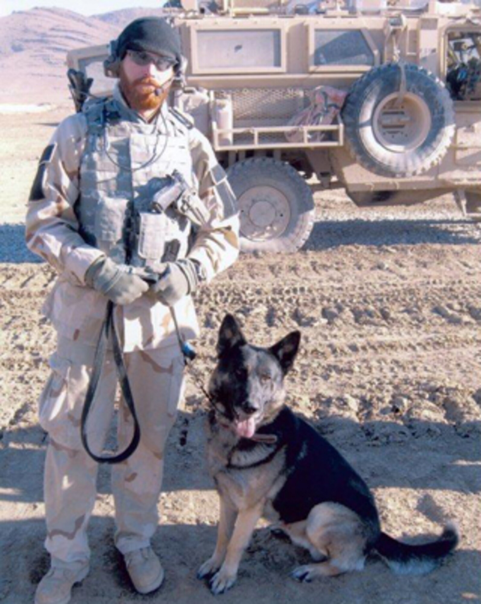 ALTUS AIR FORCE BASE, Okla. -- Staff Sgt. James Hall, 97th Security Forces kennel master and military working dog Endy help a convoy during patrols in Afghanistan. While deployed, Sergeant Hall and Endy recovered over 800 pounds of explosives and weapons and uncovered three pressure plate improvised explosive devices buried in major roadways. The Oklahoma State Chamber of Commerce recognized the heroes with the Champions of Freedom award in Oklahoma City, Okla. (Courtesy photo) 