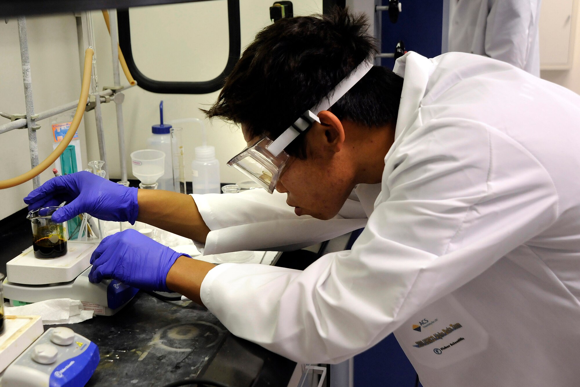 Alex Chang from Torrey Pines High School in San Diego measures the result of an experiment in a U.S. Air Force Academy's Department of Chemistry laboratory June 5. Chang was one of 20 teenage chemists here for a Chemistry Olympiad training camp, competing for one of four spots on the U.S. team that will travel to the international Chemistry Olympiad in England in July. (U.S. Air Force photo/Rachel Boettcher)