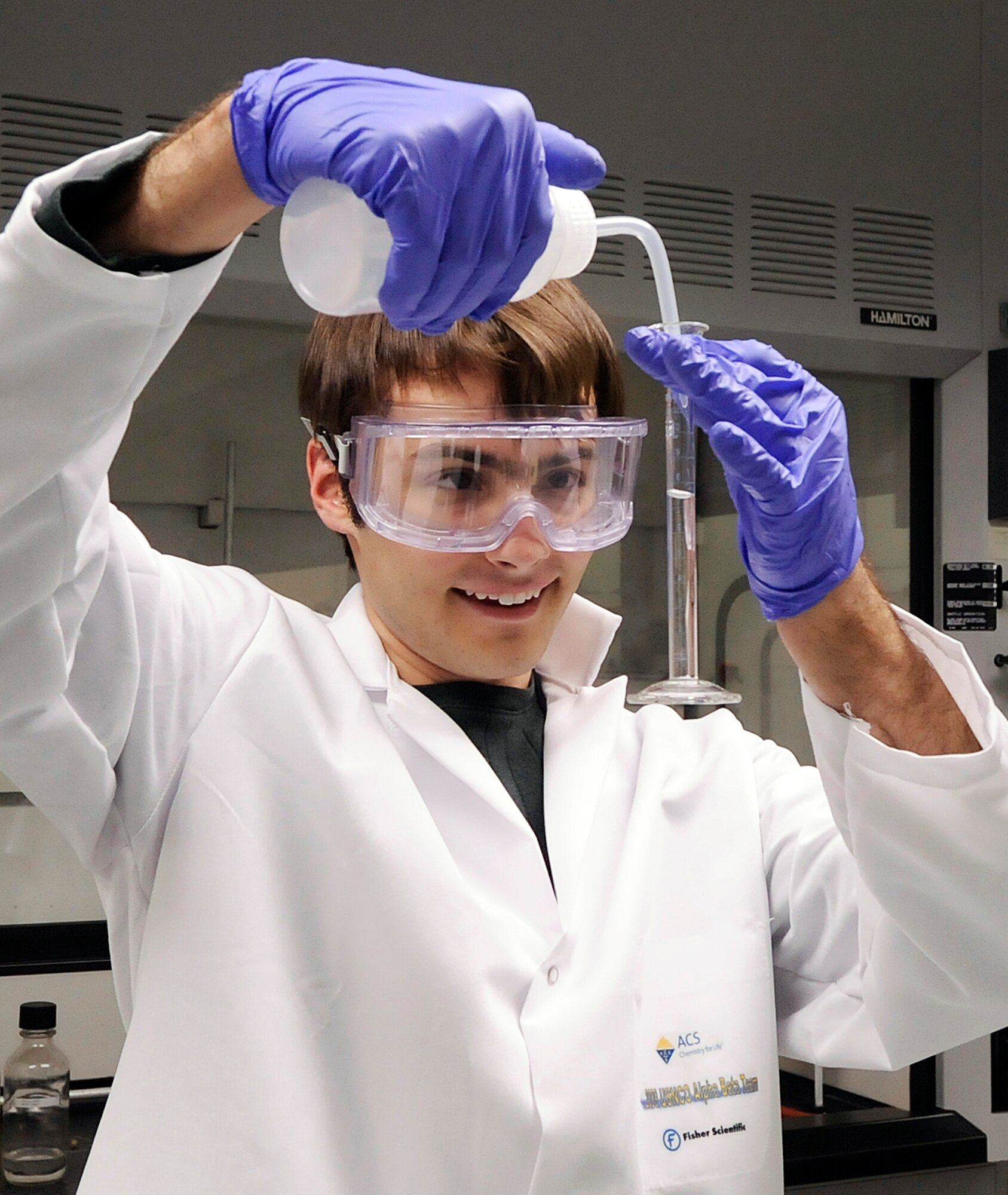 John Rosenberg from Barrington High School in Barrington, Ill., combines precise amounts of reagents during a recrystalization experiment in a U.S. Air Force Academy Department of Chemistry laboratory at the Academy June 5. Rosenberg was one of 20 teenage chemists here for a Chemistry Olympiad training camp, competing for one of four spots on the U.S. team that will travel to the international Chemistry Olympiad in England in July. (U.S. Air Force photo/Rachel Boettcher)