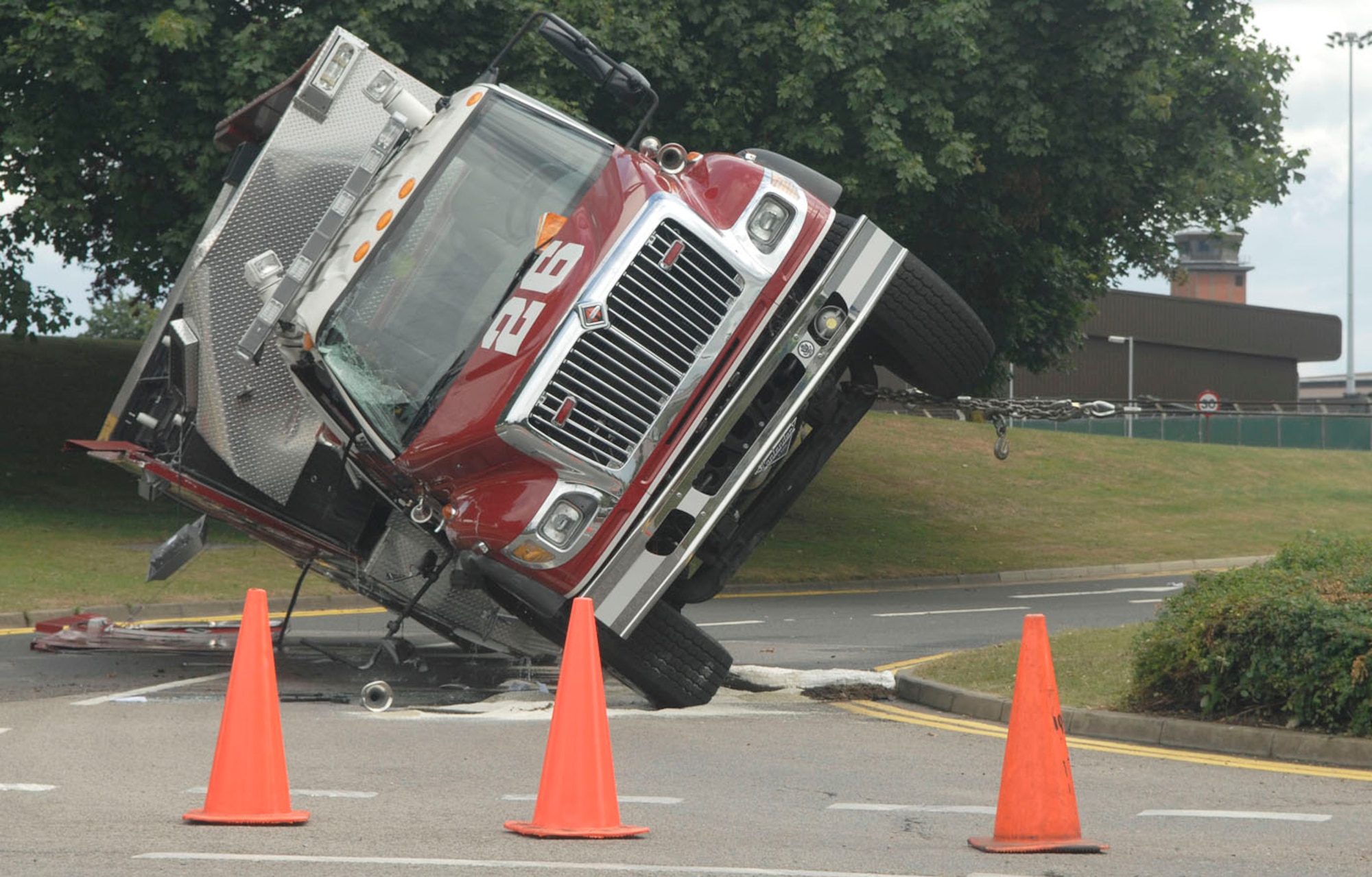 Steel winch cables from a 34-ton wrecker right an overturned 4,000-gallon water tanker on RAF Mildenhall, England, July 8 near the roundabout on Hawaii Street. The truck from the Mildenhall Fire Department was responding to a call during the accident. (U.S. Air Force photo by Senior Airman Thomas Trower)