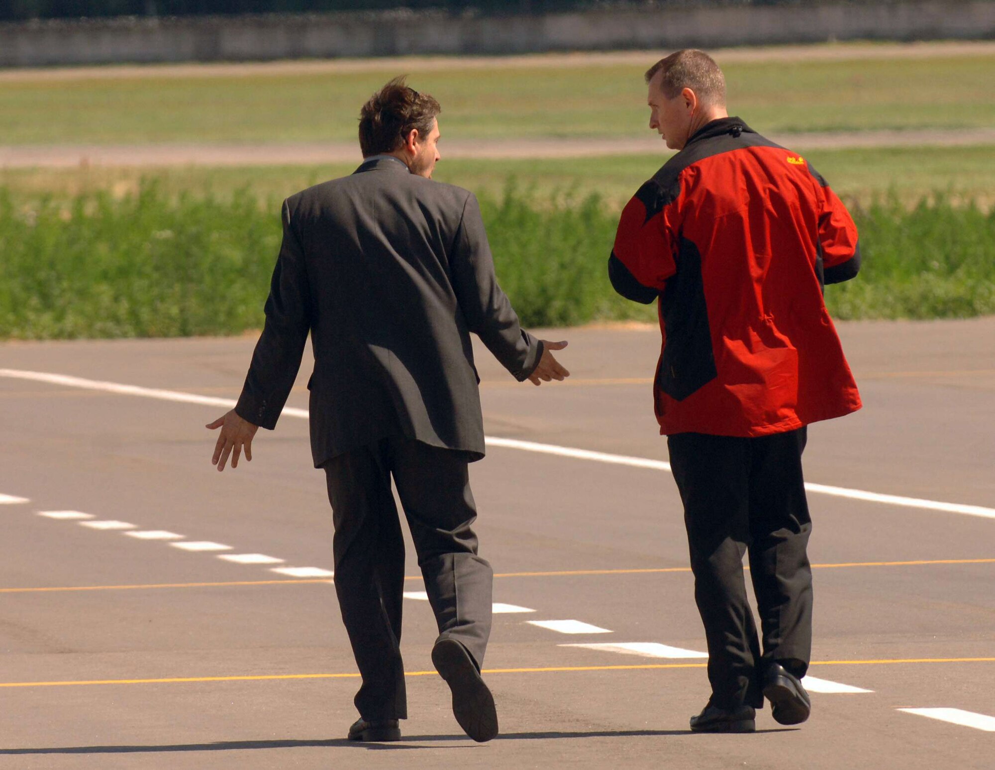 Capt. William Taylor discusses the use of portable light carts with an airport official in preparation for President Barack Obama's visit to Russia July 3 at Moscow's Vnukovo International Airport. Captain Taylor is the 86th Contingency Response Group's detachment commander of the 17-member presidential support team from Sembach Air Base, Germany. (Defense Department photo/Master Sgt. Scott Wagers)