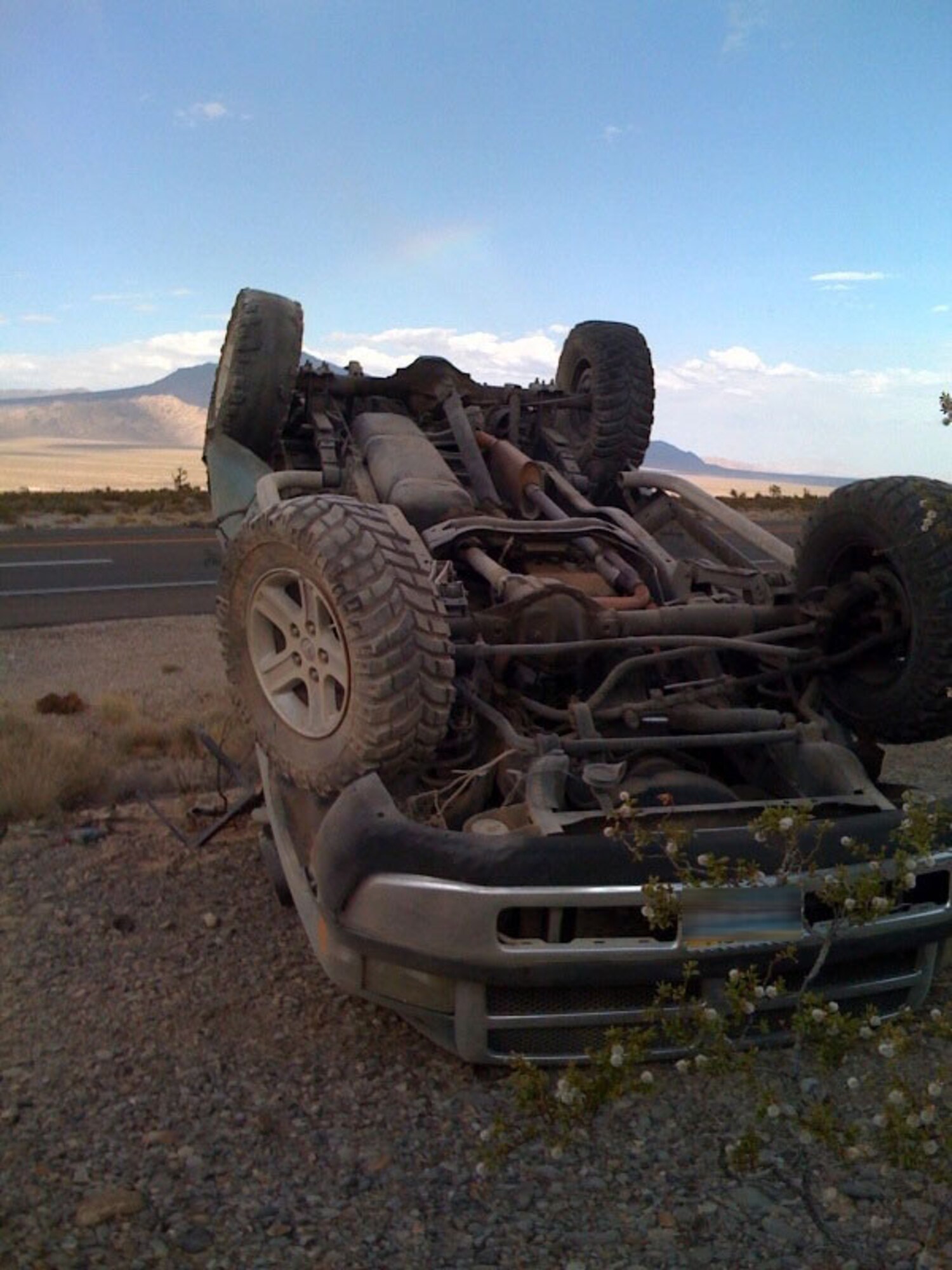 CREECH AFB, Nev. -- Senior Airman James Conlon and Senior Airman Gregory Rouleau, 42nd Attack Squadron, administered first-aid to driver of overturned vehicle pictured above.  (courtesy photo)