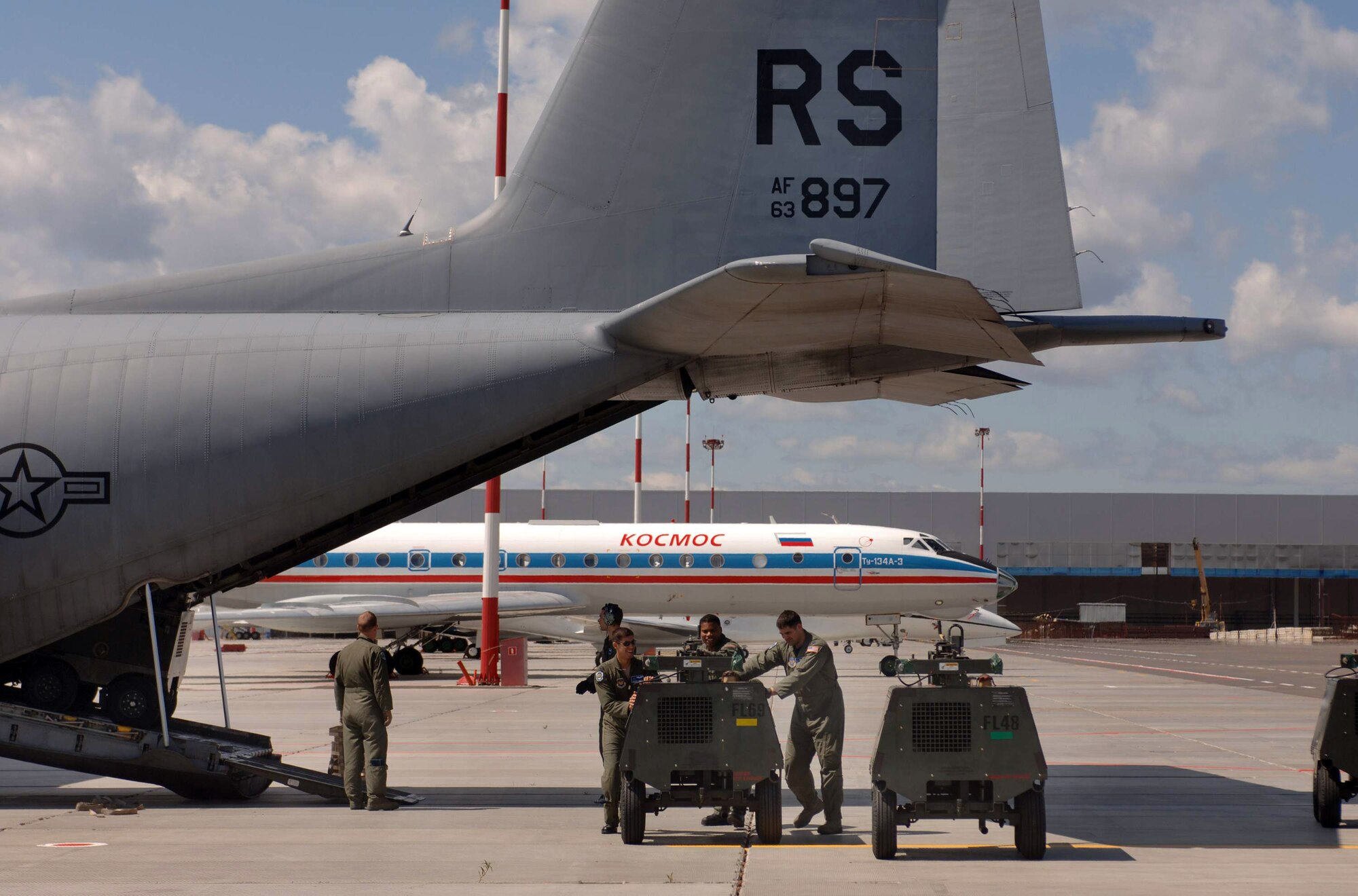Portable light carts are unloaded from one of two C-130 Hercules aircraft in preparation for President Barack Obama's visit July 3 at Moscow's Vnukovo International Airport in Russia. The two C-130s are from the 37th Airlift Squadron from Ramstein Air Base, Germany. (Defense Department photo/Master Sgt. Scott Wagers) 