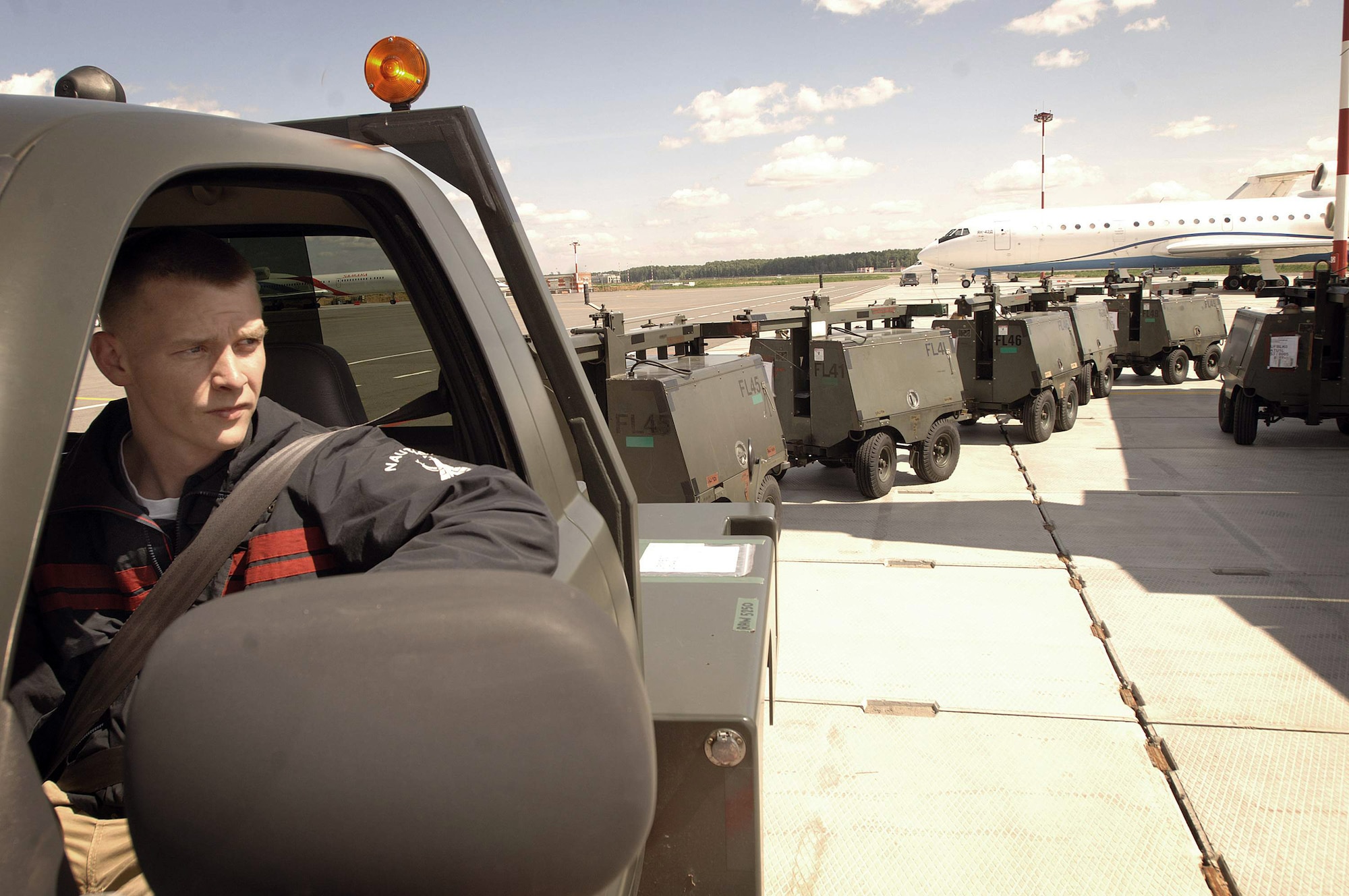 Staff Sgt. Andrew Bowman prepares to tow portable light carts to a temporary storage facility July 3 at Moscow's Vnukovo International Airport in Russia. The equipment delivered from Ramstein Air Base, Germany, is in preparation for President Barack Obama's visit to Russia. Sergeant Bowman is an aerial transporter assigned to the 86th Contingency Response Group at Sembach Air Base, Germany. (Defense Department photo/ Master Sgt. Scott Wagers)