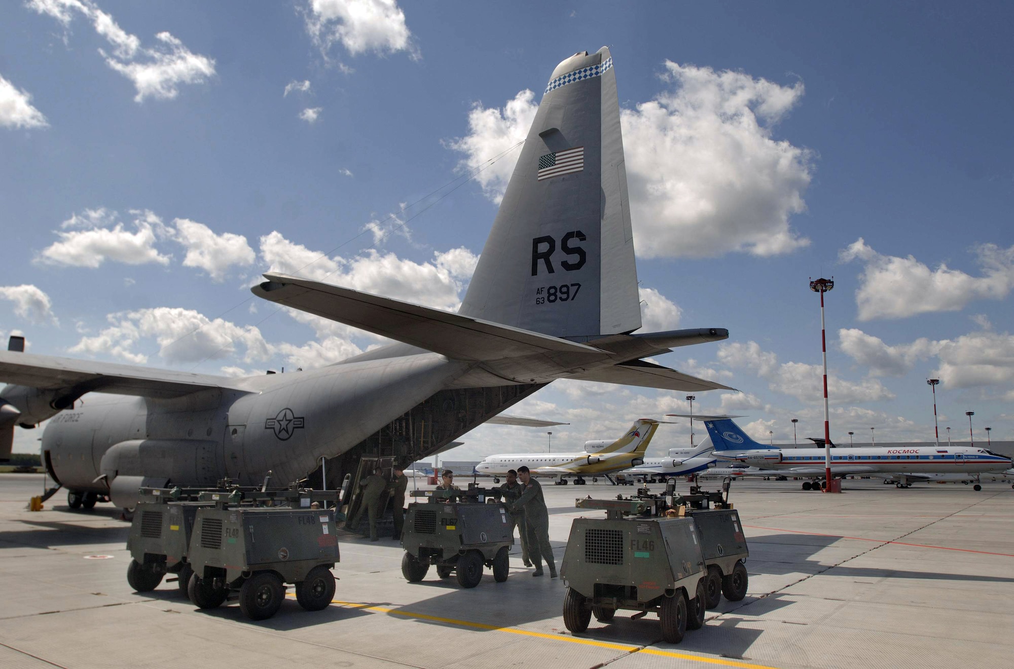 Portable light carts are unloaded onto the tarmac from one of two C-130 Hercules July 3 at Moscow's Vnukovo International Airport in Russia. The C-130s are from the 37th Airlift Squadron from Ramstein Air Base, Germany. The C-130 aircrews delivered equipment in preparation for President Barack Obama's visit to Moscow. (Defense Department photo/Master Sgt. Scott Wagers)