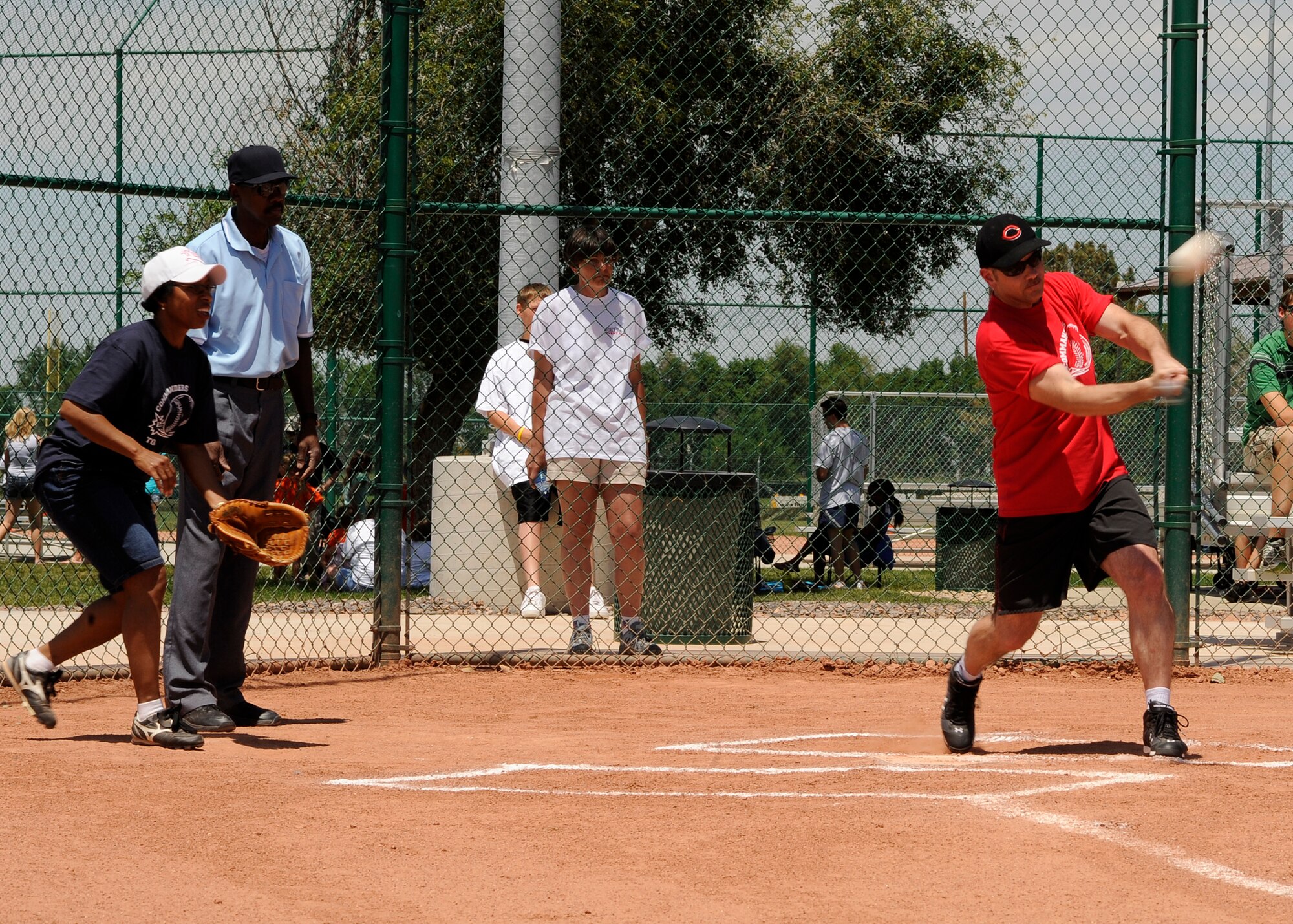 BUCKLEY AIR FORCE BASE, Colo. –Dale Armstrong, Senior Enlisted Manager, 566th Intelligence Squadron, Aerospace Data Facility- Colorado, connects with the ball during the Commanders vs. Top 3 Softball Game at Freedom Fest here, July 1.  The Top 3 took the game with a score of 18-11.  The celebration included food, events for children and a live band.  (U.S. Air Force photo by Senior Airman Steven Czyz)