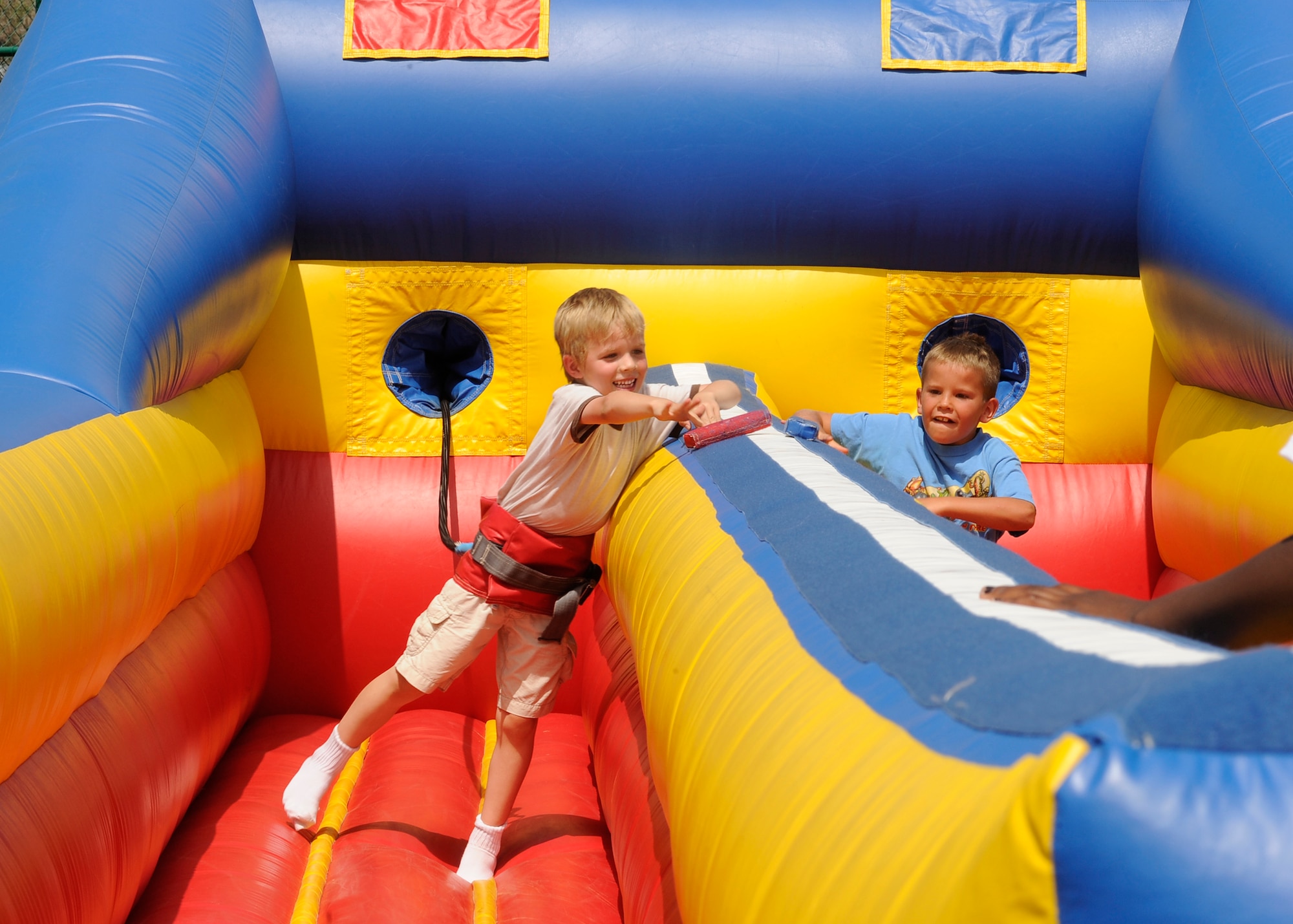 BUCKLEY AIR FORCE BASE, Colo. – Jonah Croker, son of Capt. Barry Croker, 2nd Space Warning Squadron, competes with another child on the bungee run during Freedom Fest here, July 1.  Along with events for children there was food, live music and raffle prize giveaways.  (U.S. Air Force photo by Senior Airman Steven Czyz)