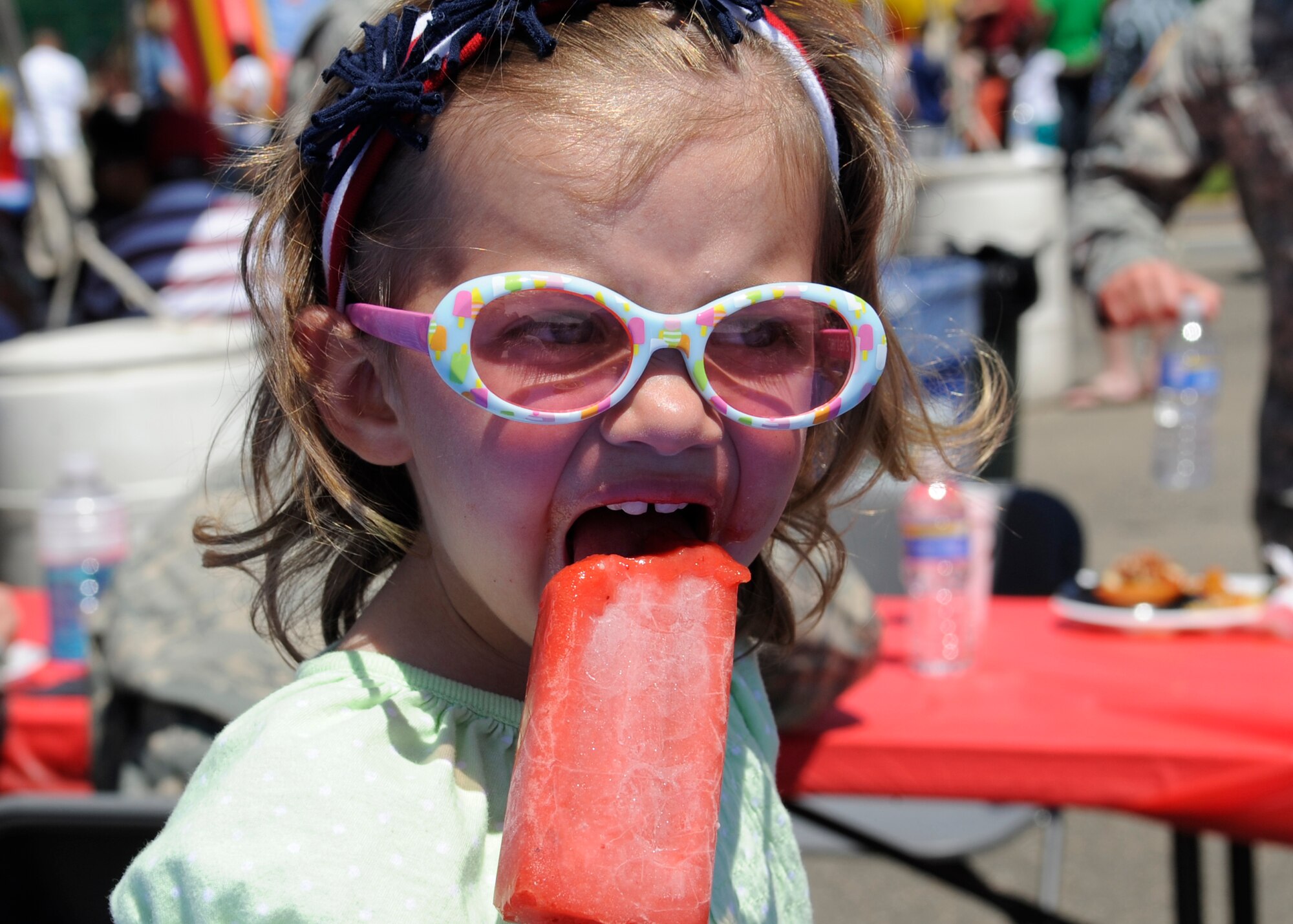 BUCKLEY AIR FORCE BASE, Colo. -- Alexandra Valdes, daughter of Sgt. Adam Valdes, 743rd Military Intelligence Battalion, devours a frozen treat during Freedom Fest here, July 1.  Along with various foods there were events for children, raffle prize giveaways and live music. (U.S. Air Force photo by Tech. Sgt. Jeromy Cross)