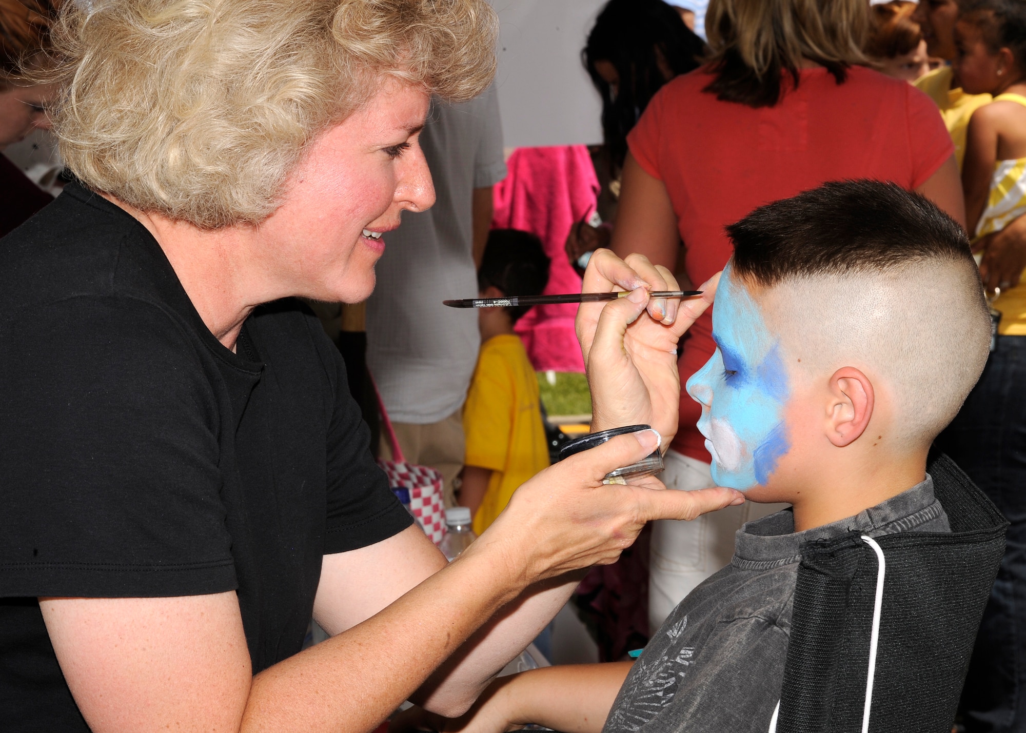 BUCKLEY AIR FORCE BASE, Colo. – Mathew Smith, son of Staff Sgt. Lee Smith, 743rd Military Intelligence Battalion, gets his face painted during Freedom Fest here, July 1.  The celebration included food, events for children and a live band. (U.S. Air Force photo by Senior Airman Steven Czyz)