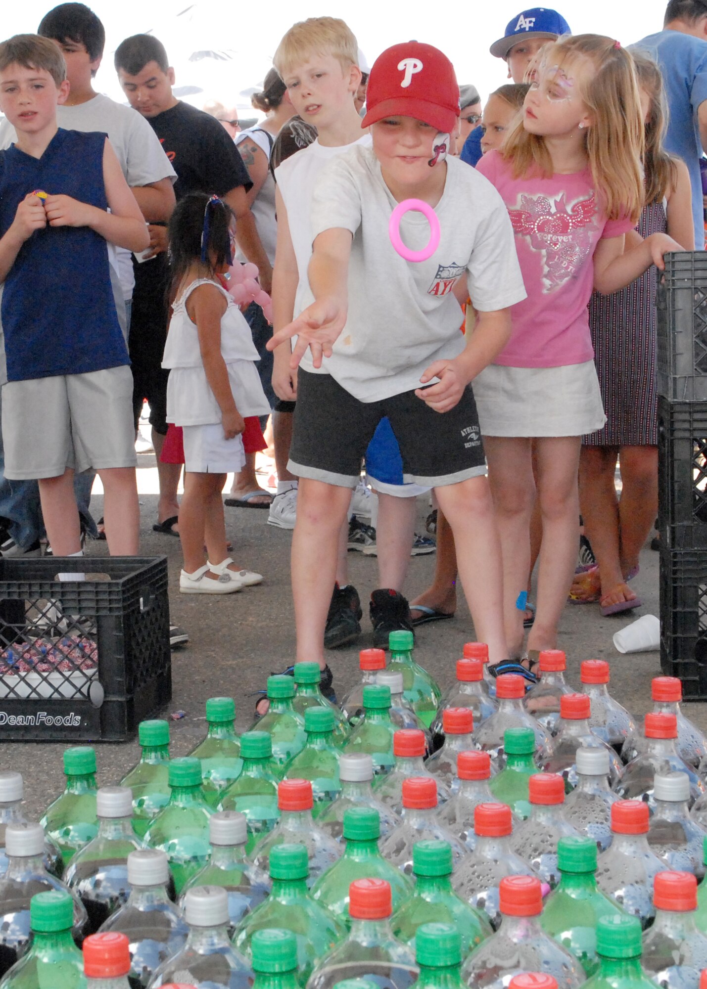 BUCKLEY AIR FORCE BASE, Colo. -- Matt McClanahan, son of Tom McClanahan, 2nd Space Warning Squadron contractor, tosses a ring on soda bottles in hopes of winning a two-liter beverage at Freedom Fest here, July 1.  Along with games and events for children there was food, raffle prize giveaways and live music. (U.S. Air Force photo by Tech. Sgt. Shirley Henderson)