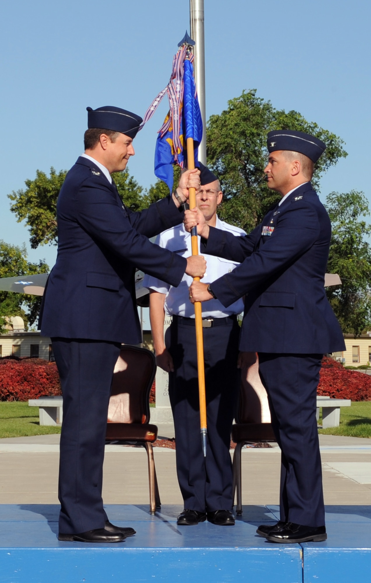 MOUNTAIN HOME AIR FORCE BASE, Idaho -- Col. John Bird, 366th Fighter Wing commander, passes the 366th Medical Group guidon to Col. Kevin Connolly, incoming 366th Medical Group commander, July 7 during a change-of-command ceremony at Holt Park. Colonel Connolly comes to the Gunfighters from Washington D.C. where he was a student at the Industrial College of the Armed Forces. (U.S. Air Force photo/ Airman 1st Class Debbie Lockhart)