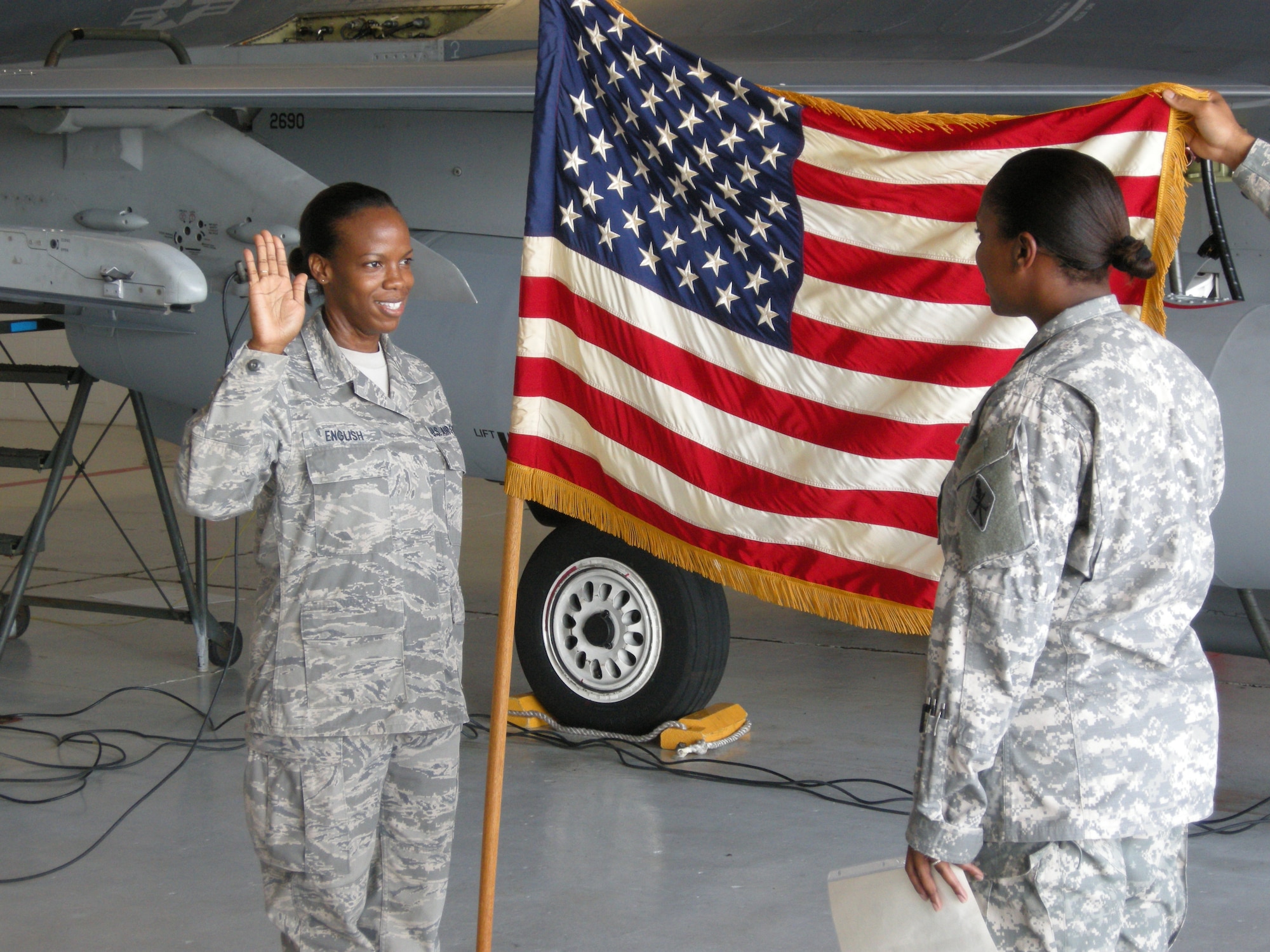 SHAW AIR FORCE BASE, S.C. -- Staff Sgt. Dorothy English is administered the oath of enlistment by Army 2nd Lt. Judith Morgan, her older sister.  (U.S. Air Force photo)