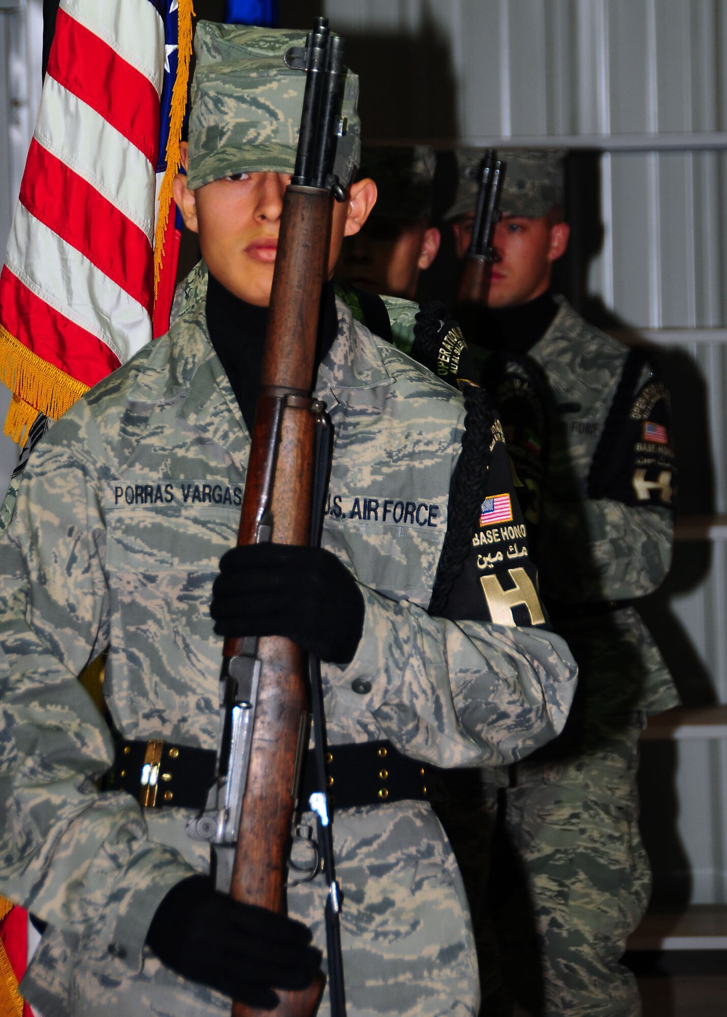 Airman 1st Class Luis Porras Vargas, 386th Air Expeditionary Wing honor guard member, marches into position to post the colors during the 386th Expeditionary Operations Group change of command ceremony July 7.  Members of the 386th honor guard volunteer their time while deployed to conduct official ceremonies and functions.   (U.S. Air Force photo/Tech Sgt. Tony Tolley)
