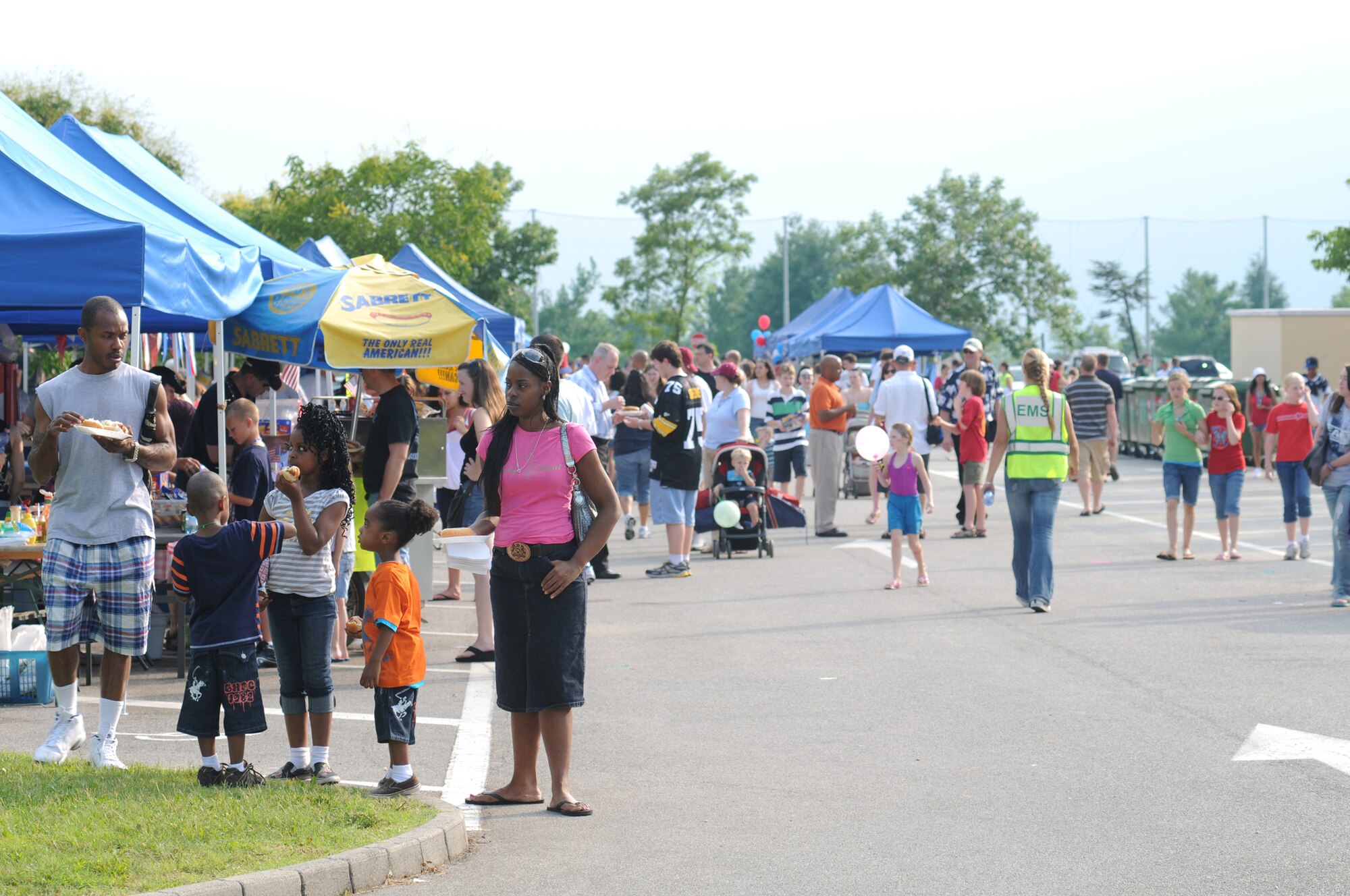 Aviano Air Base family members enjoy the food and entertainment booths here during the 4th of July Celebration. The 4th of July Celebration consisted of various events throughout the day and concluded with a fireworks display at night commemorating 233 years of Independence. (U.S. Air Force photo/ Staff Sgt. Patrick Dixon)