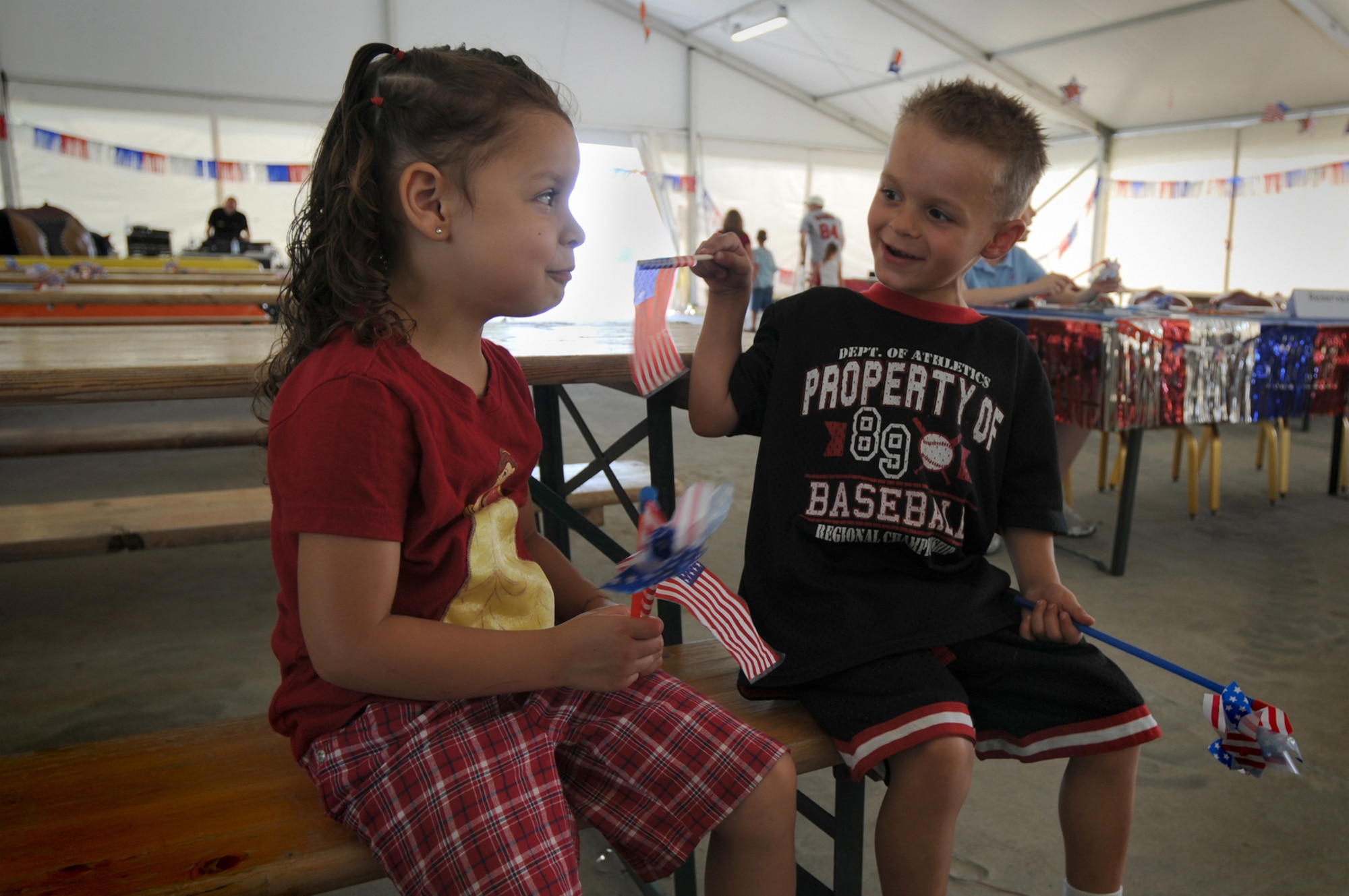 Camron MacCourt (right), son of Michaela and Staff Sgt. Robert MacCourt, plays with his cousin Lateasha Vermette here during the 4th of July Celebration. The 4th of July Celebration consisted of various events throughout the day and concluded with a fireworks display at night commemorating 233 years of Independence. (U.S. Air Force photo/ Staff Sgt. Patrick Dixon)