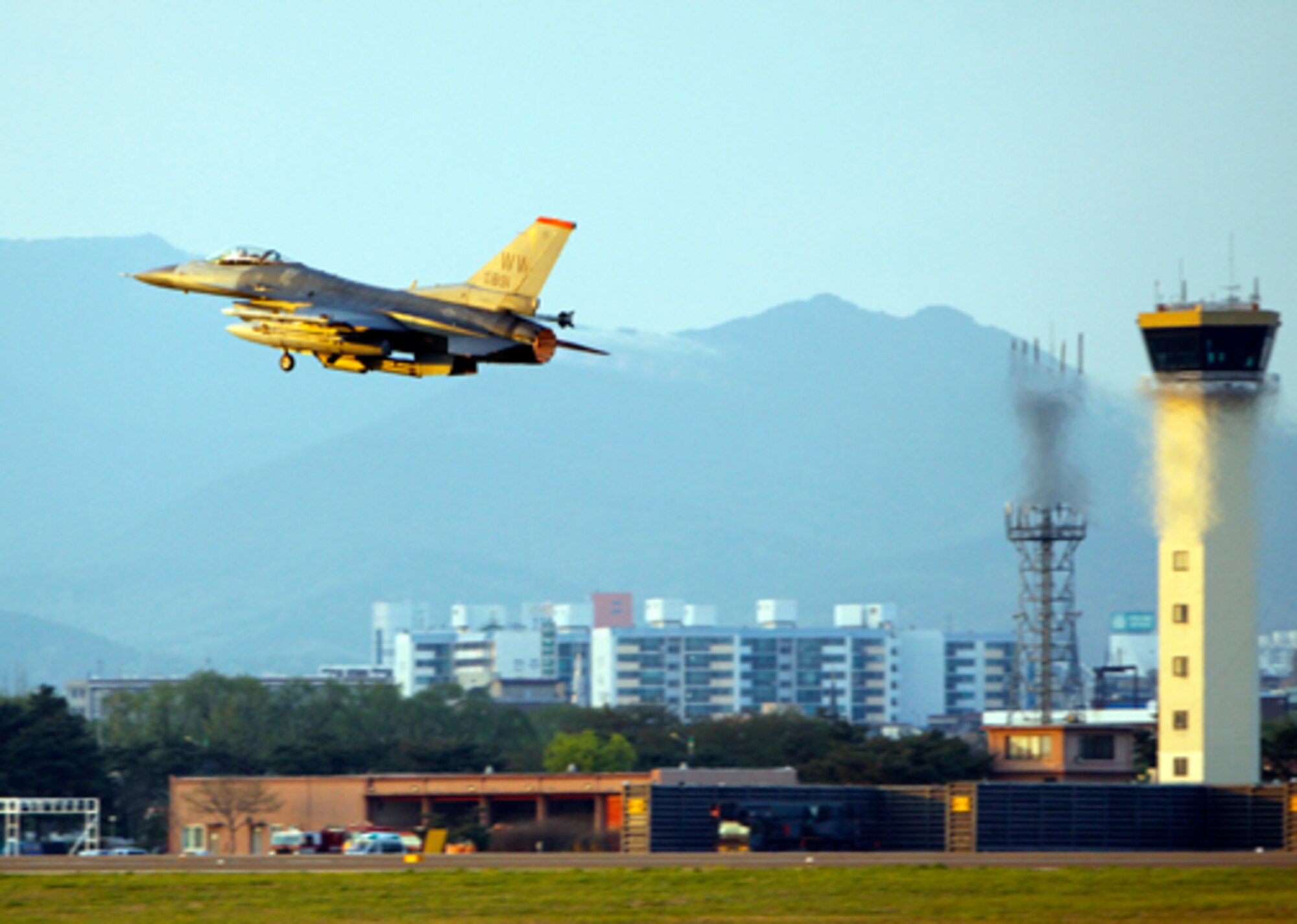 SUWON AIR BASE. Republic of Korea -- An F-16 Fighting Falcon takes to the air for a training mission June 16 from Suwon Air Base. The 13th Expeditionary Fighter Squadron deployed to the RoK as part of a  theater security package. (Air Force photo/Senior Master Sgt. Wayne Cardwell) 