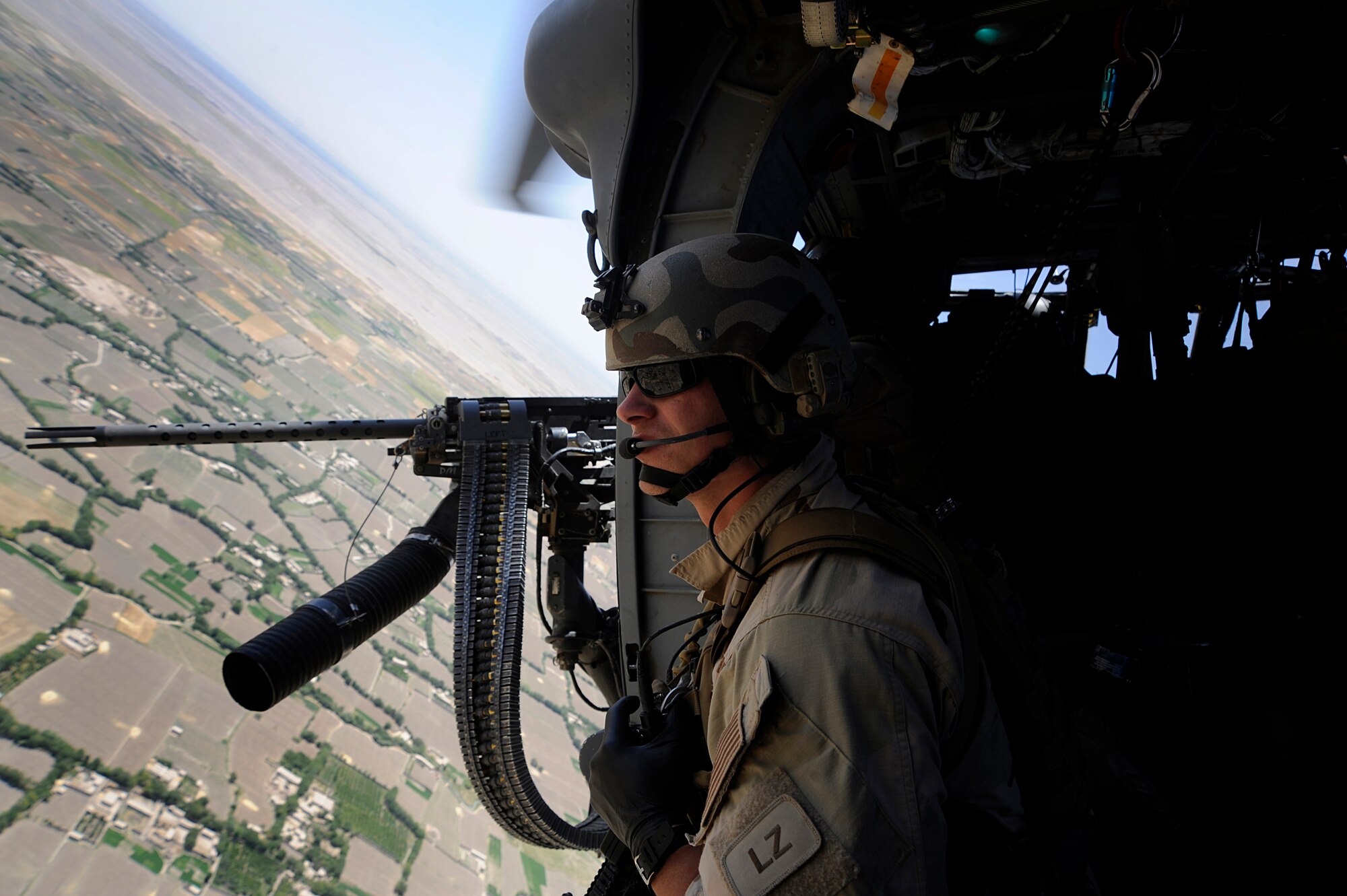 From the side of an HH-60G Pave Hawk, Senior Airman Clint Lentz, pararescueman with the 129th Expeditionary Rescue Squadron, watches for any potential dangers prior to landing June 26, 2009, Hemland Province, Afghanistan. Airman Lentz and the rest of the crew are responding to a Medevac request to aid personnel conducting combat operations further down range.  (U.S. Air Force photo by Staff Sgt. Shawn Weismiller)