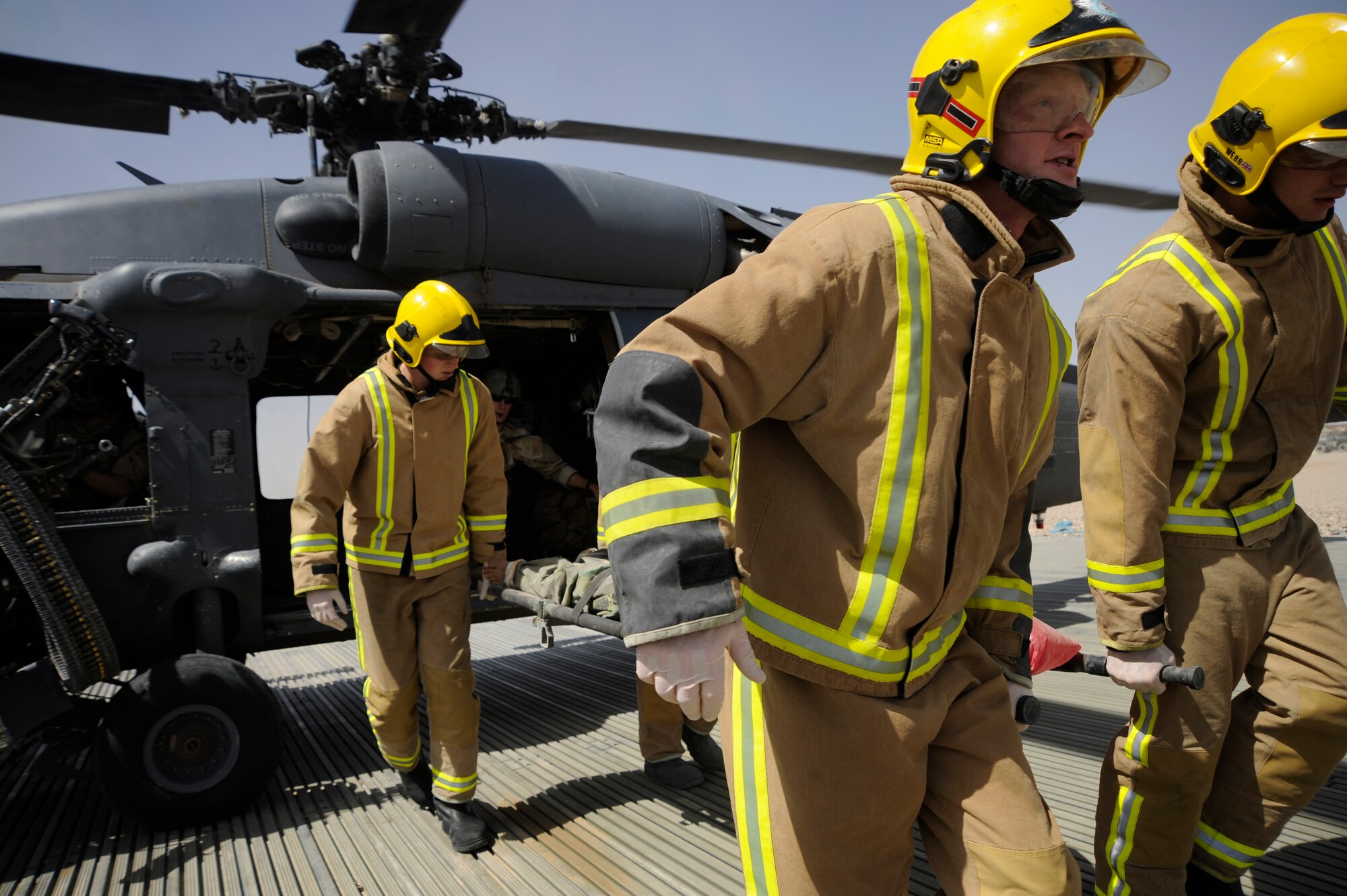 British Fire and Rescue personnel carry a wounded Afghan National Army Soldier off an HH-60G Pave Hawk so he he can be tranferred to a hospital June 26, 2009, Camp Bastion, Afghanistan.  (U.S. Air Force photo by Staff Sgt. Shawn Weismiller)