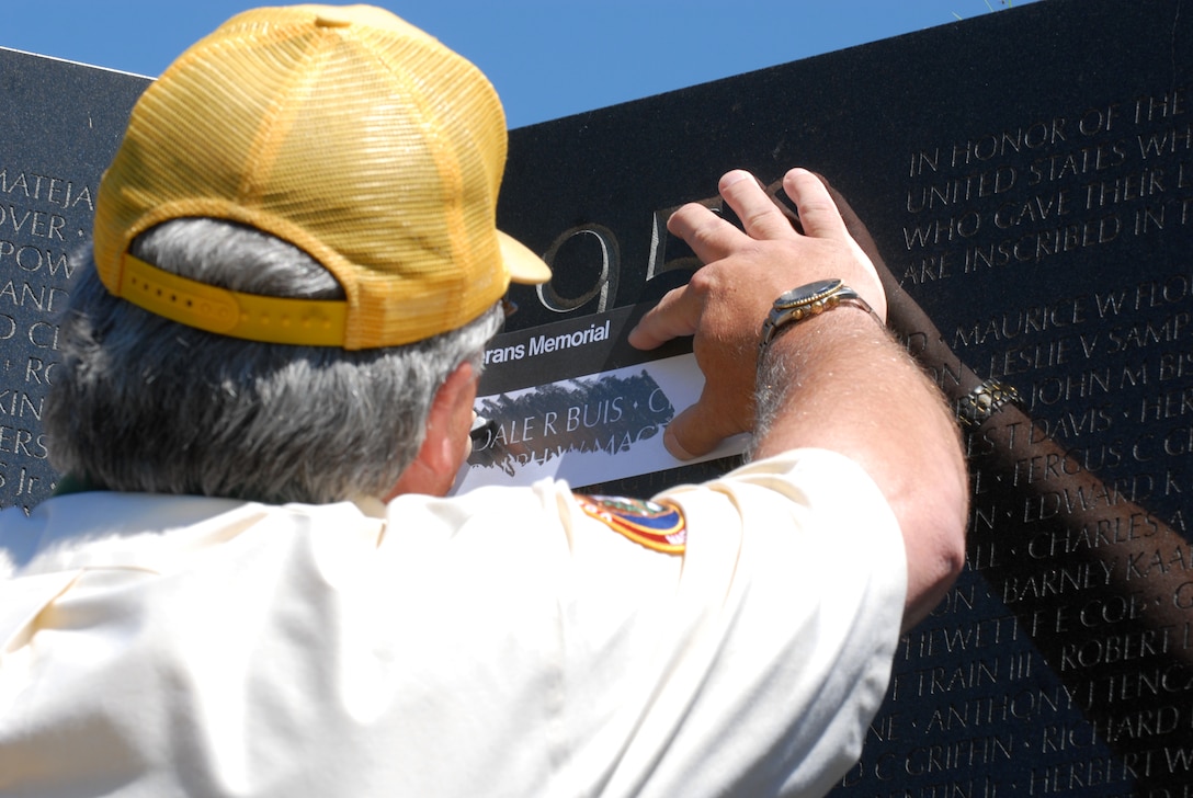 Allen McCabe, a National Park Service volunteer, does a pencil rubbing of Amry Maj. Dale Buis' name located on panel 1E of the Vietnam War Memorial Wall in Washington, D.C., July 8, 2009. The rubbing was completed after a ceremony commemorating the 50th Anniversary of the deaths of Buis and Army Master Sgt. Chester Ovnand,who were serving in Bien Hoa, South Vietnam, as part of the U.S. Military Assistance Advisory Group.
