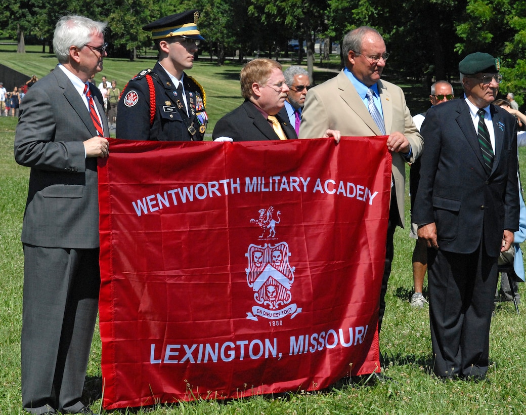 Participants hold a flag reading “Wentworth Military Academy Lexington, Missouri” during the Vietnam Veterans Memorial Fund ceremony marking the 50th anniversary of the first two U.S. servicemembers to die in the Vietnam War at the Vietnam War Memorial in Washington, D.C., July 8, 2009