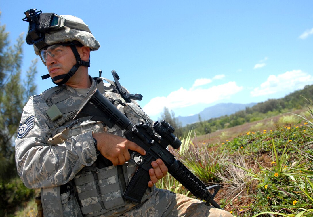 U.S. Air Force Tech. Sgt. Alejandro Castillo provides overwatch for a patrol checking on the validity of a possible improvised explosive device during a field training exercise, June 24, 2009, on Wheeler Army Airfield's East Range, Hawaii. 