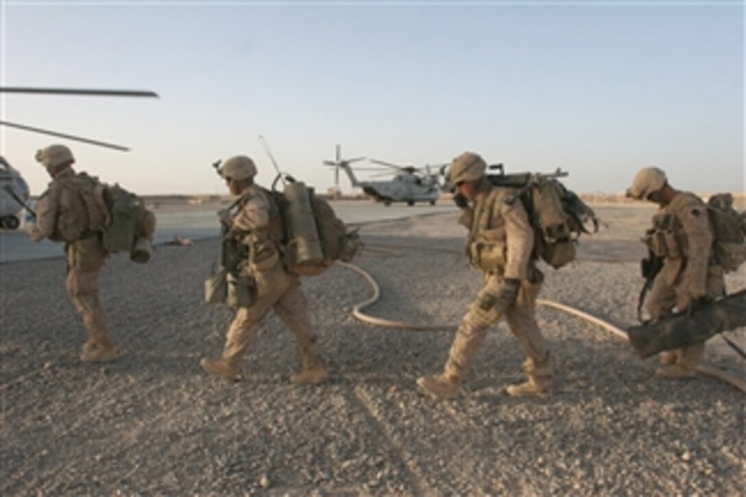 U.S. Marines with 2nd Battalion, 8th Marine Regiment, Regimental Combat Team 3, 2nd Marine Expeditionary Brigade prepare to board CH-53D Sea Stallion and CH-53E Super Stallion helicopters at Forward Operating Base Dwyer, Afghanistan, on July 2, 2009.  The Marines are working with the Afghan National Security Force to build and transition security responsibilities for the Helmand province to Afghan forces.  