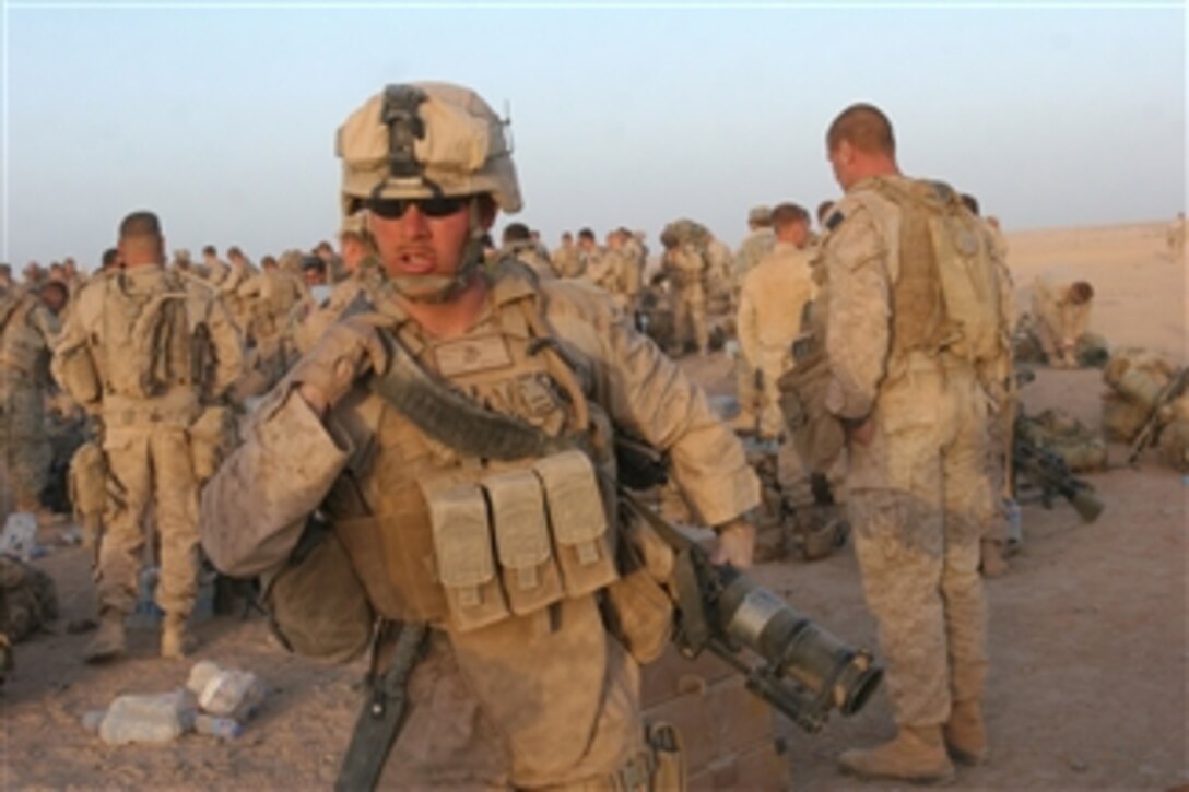 U.S. Marines with 2nd Battalion, 8th Marine Regiment, Regimental Combat Team 3, 2nd Marine Expeditionary Brigade, along with Afghan soldiers and police officers from the Afghan National Security Force, prepare to board CH-53D Sea Stallion and CH-53E Super Stallion helicopters at Forward Operating Base Dwyer, Afghanistan, on July 2, 2009.  The Marines and the Afghan National Security Force are partnered for an operation in the Helmand province to transition security responsibilities to the Afghan forces.  