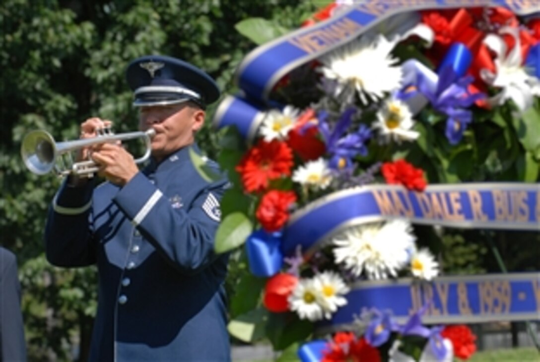 A U.S. Air Force bugler plays taps at a ceremony in Washington, D.C., July 8, 2009, in honor of the 50th Anniversary of the first two U.S. servicemembers killed in the Vietnam War. U.S. Army Master Sgt. Chester Ovnand and Maj. Dale Buis were killed at their base camp in Bien Hoa, just north of Saigon, Vietnam.