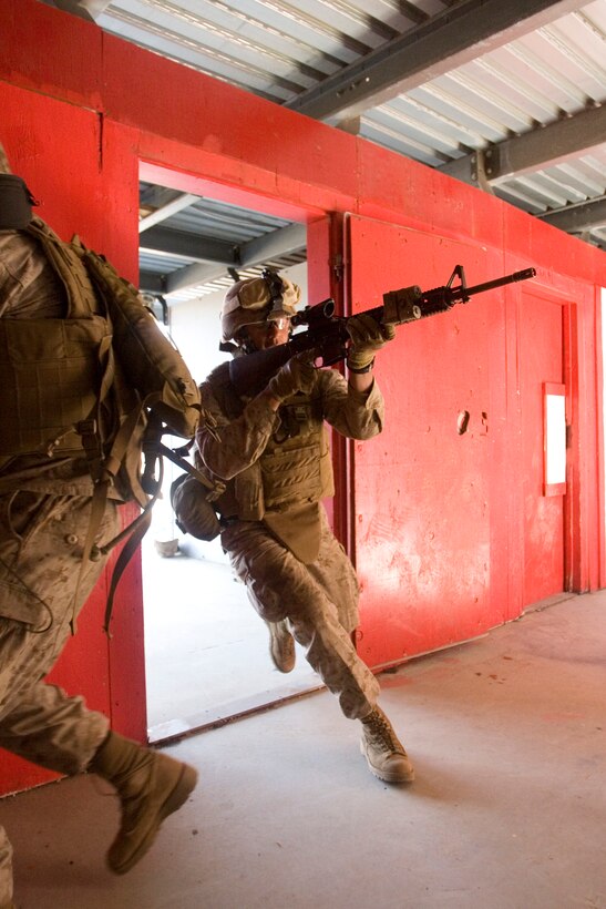 Lance Cpl. Michael Bain, 3rd Platoon, Alpha Company, 1st Battalion, 3rd Marine Regiment, quickly “button hooks” into a doorway to engage simulated targets at Range 1 near the Pohakuloa Training Area July 8. The training, practicing military operations in urban terrain, is part of Exercise Lava Viper. Lava Viper is part of 1/3’s predeployment training package.