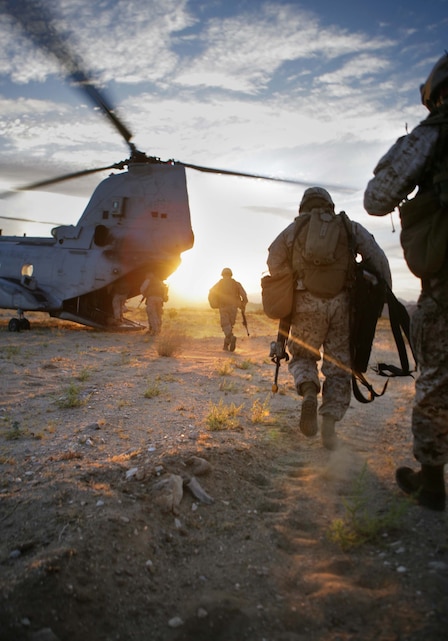 Company E Marines run to a CH-46 helicopter after completing a long-range helicopter raid at Twentynine Palms, Calif., July 8. The company – one of four that make up Battalion Landing Team 2/4, the 11th Marine Expeditionary Unit’s ground combat element – departed USS Bonhomme Richard in six CH-46s, two CH-53s and other aircraft. The MEU, part of the Bonhomme Richard Amphibious Ready Group, is conducting its first pre-deployment exercise at sea with its Navy counterpart, Amphibious Squadron 7. This Navy and Marine Corps team is testing interoperability before a deployment certification exercise later this summer.