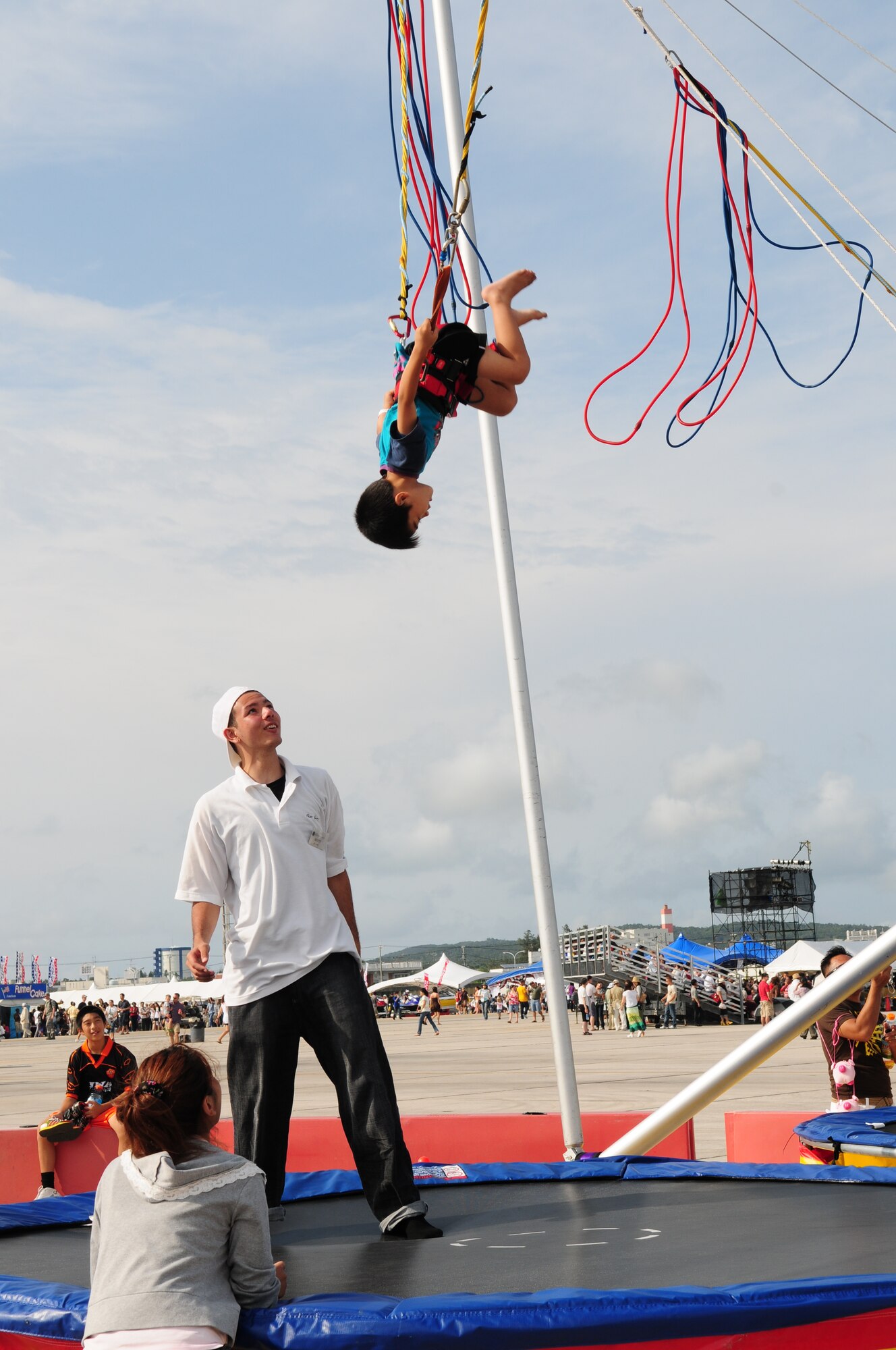 An Okinawan child tries out the trampoline swing at AmericaFest 2009 at Kadena Air Base, Japan, July 4. (U.S. Air Force photo/Staff Sgt. Lakisha Croley)             