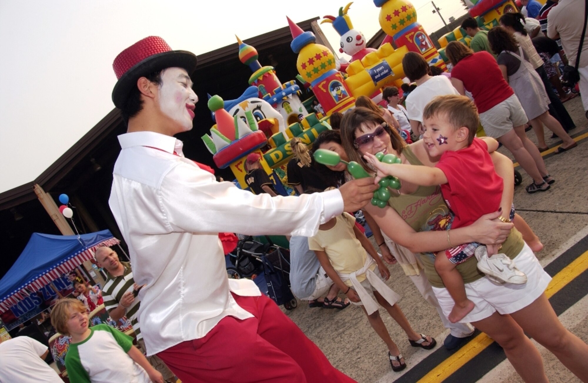 Members of Team Osan, along with the local community, enjoy themselves during the 2009 Liberty Fest hosted by the 51st Force Support Squadron. Among some of the annual Independence Day activities included Korean cultural dancing, Korean drums and entertainment, live bands, break dancing performance, dunking booth, aircraft static displays and the night’s grand finale, of a fireworks.  (U.S. Air Force photo/Tech. Sgt. Raymond Winstead)