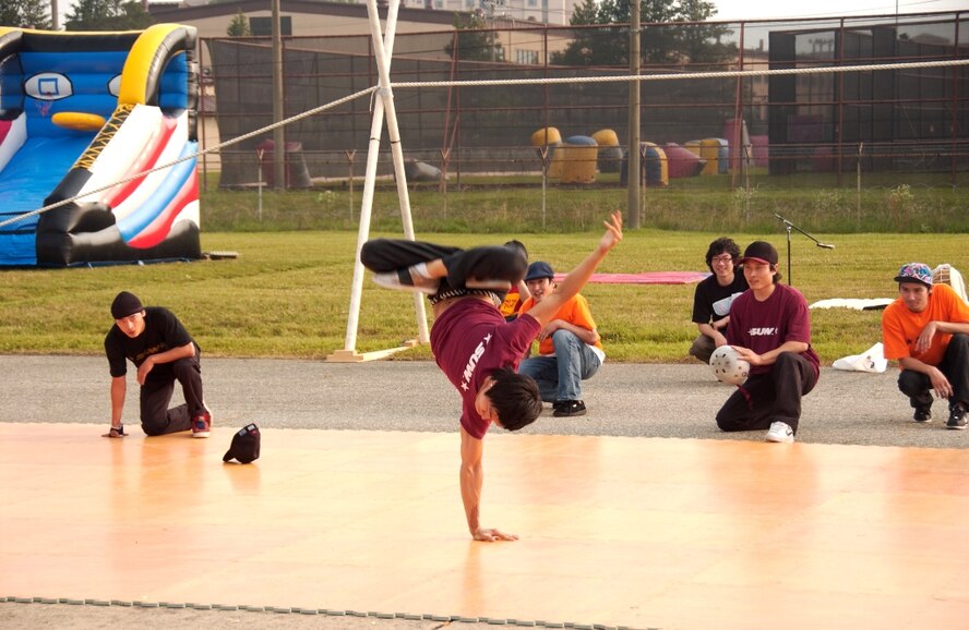A member of the “B” Boy break dance group does a one armed hand-stand during the group’s Liberty Fest performance here. (U.S. Air Force photo/Tech. Sgt. Raymond Winstead)