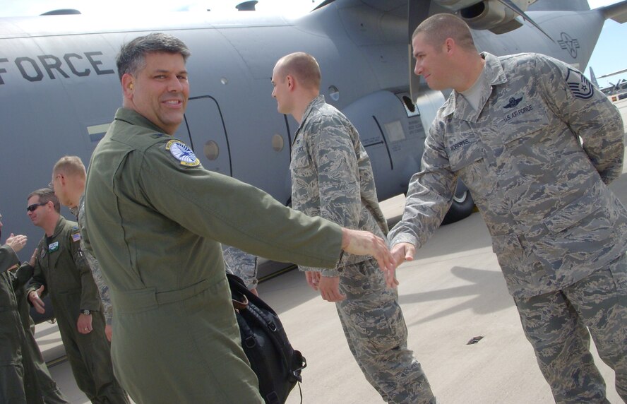 Col. Gregory Otey, 19th Airlift Wing commander, shakes hands with Master Sgt. William Roberts July 9 after landing at Peterson Air Force Base, Colo. Colonel Otey, together with other 19th AW leadership, briefly visited the Air Force Reserve's 302nd Airlift Wing during a stopover at the base. The 302nd AW is taking on an active association mission in the fall, integrating Active Duty Airmen into the AF Reserve mission at Peterson. The 19th AW is based at Little Rock AFB, Ark. (U.S. Air Force photo/Staff Sgt. Stephen J. Collier)