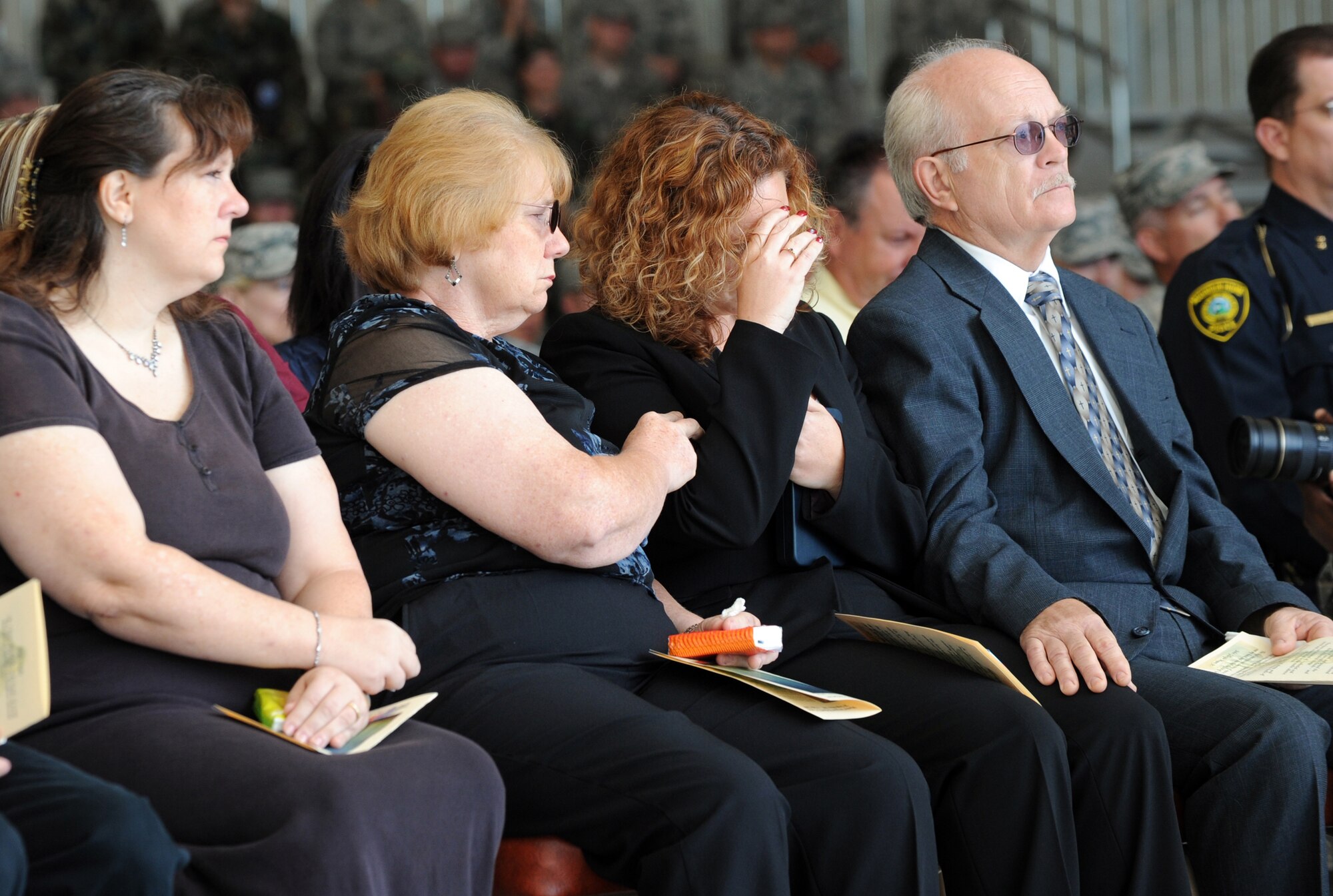 MOUNTAIN HOME AIR FORCE BASE, Idaho - Tina Caron, wife of Master Sgt. Richard Caron, is comforted by family members during a memorial ceremony at Hangar 1331 July 9. Sergeant Caron was with the 366th Aircraft Maintenance Squadron and passed away in Mountain Home July 4. (U.S. Air Force photo/Airman 1st Class Deborah Lockhart)